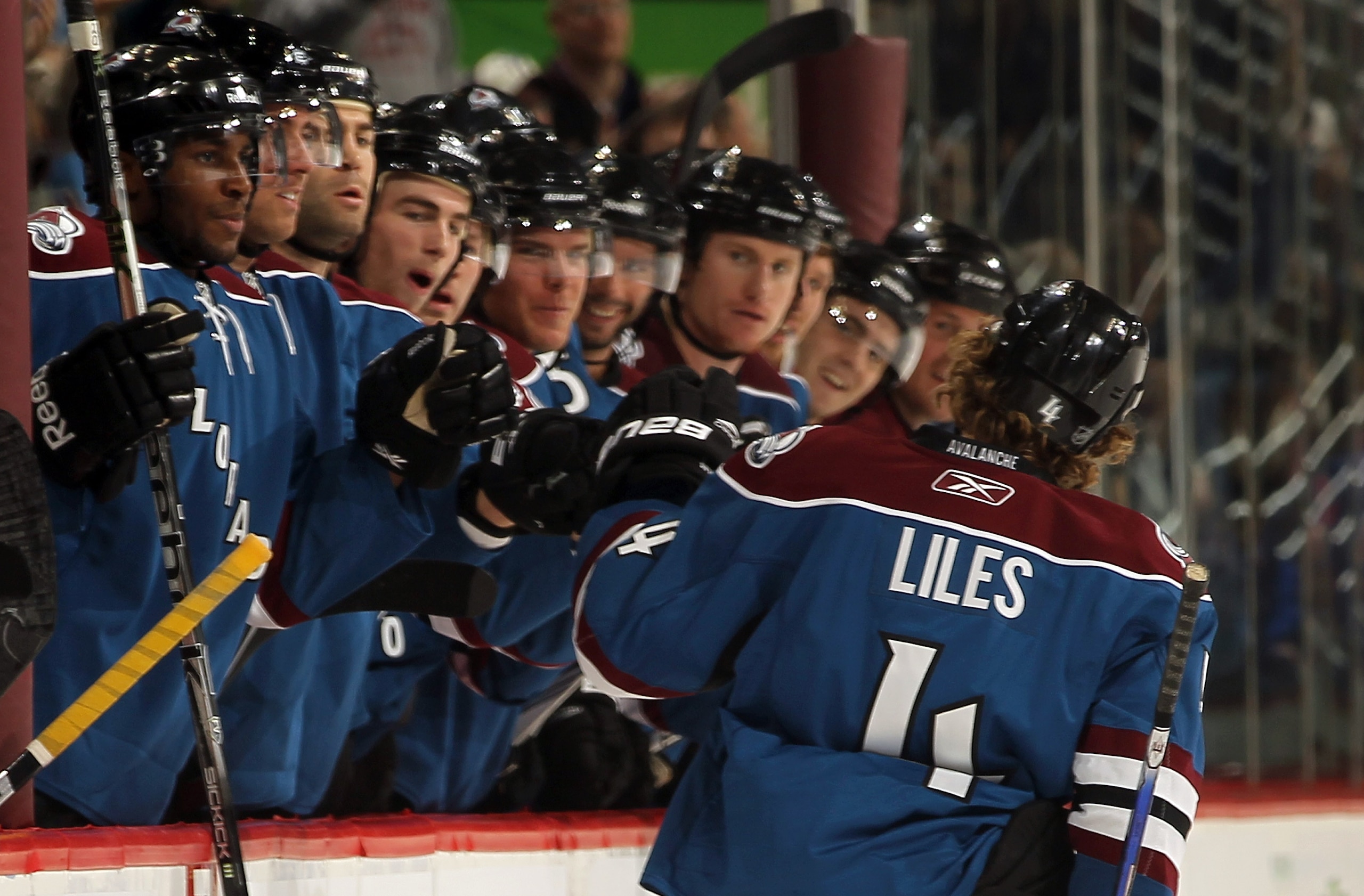 DENVER - NOVEMBER 15:  Defenseman John-Michael Liles #4 of the Colorado Avalanche is congratulated for his goal against the St. Louis Blues at the Pepsi Center on November 15, 2010 in Denver, Colorado. Liles had two goals as the Avalanche defeated the Blu