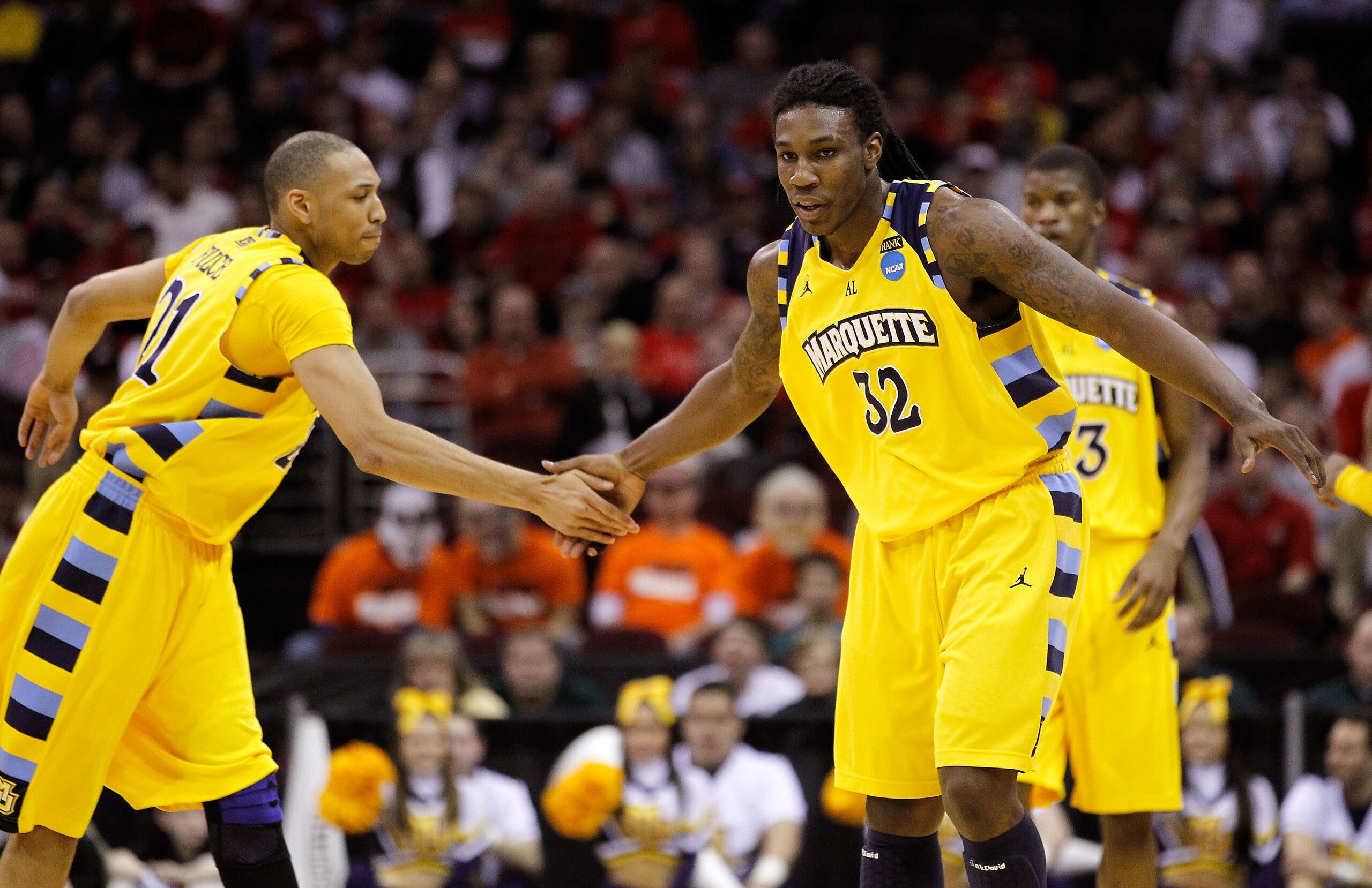CLEVELAND, OH - MARCH 20: Jae Crowder #32 and Joseph Fulce #21 of the Marquette Golden Eagles celebrate after a play in the first half against the Syracuse Orange during the third of the 2011 NCAA men's basketball tournament at Quicken Loans Arena on Marc