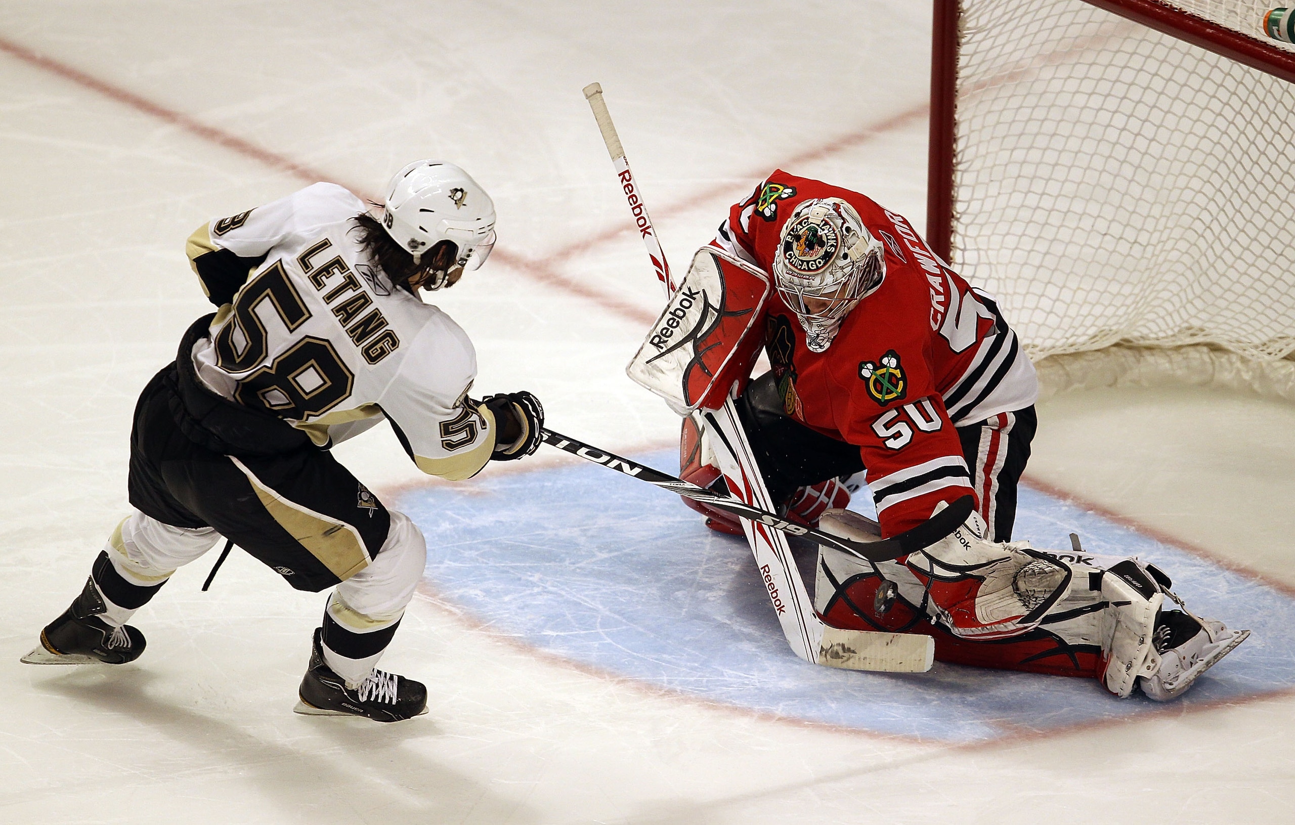 CHICAGO, IL - FEBRUARY 20: Corey Crawford #50 of the Chicago Blackhawks makes a save against Kris Letang #58 of the Pittsburgh Penguins during the shootout at the United Center on February 20, 2011 in Chicago, Illinois. The Blackhawks defeated the Penguin