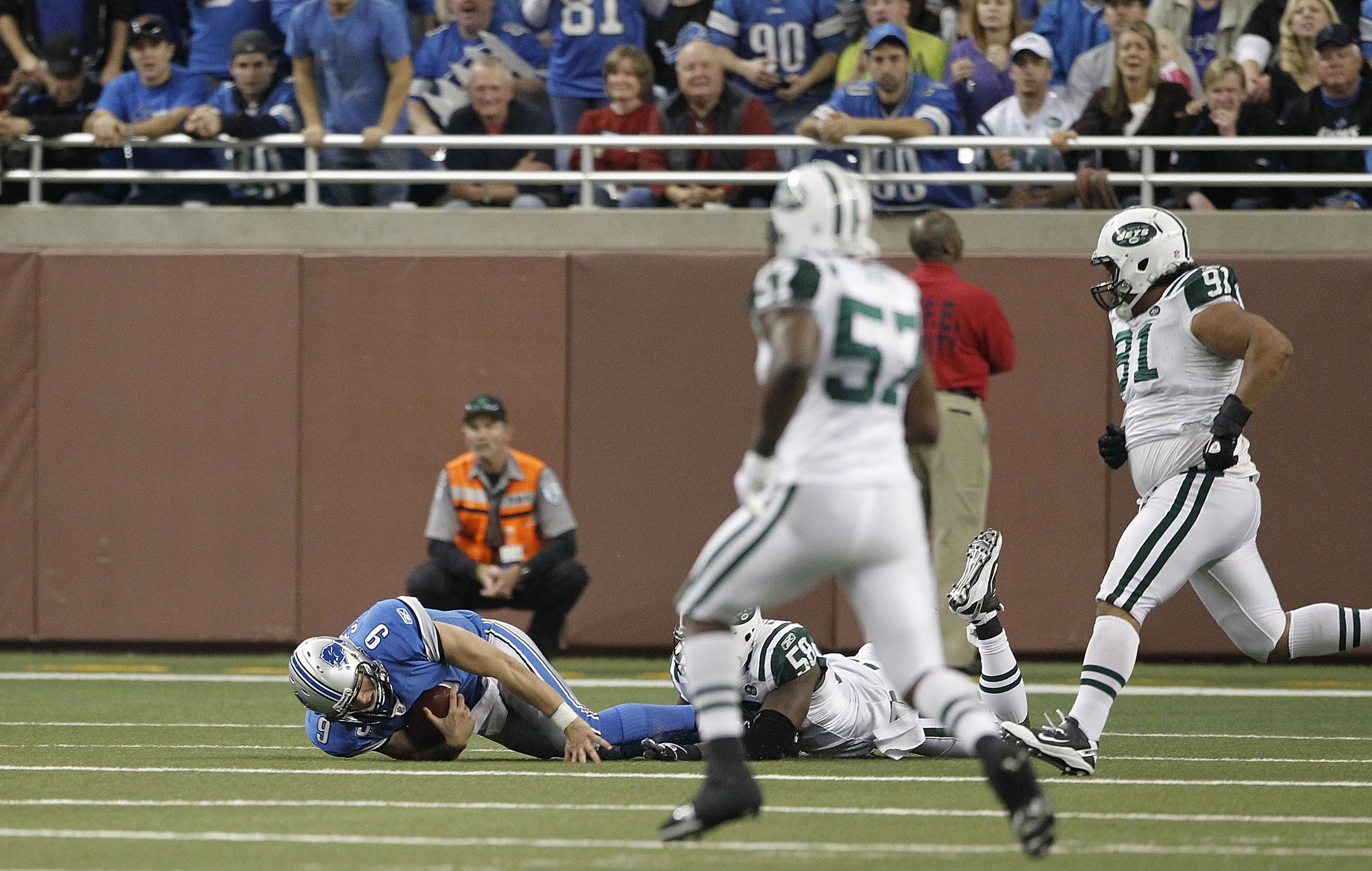 DETROIT - NOVEMBER 07: Matthew Stafford #9 of the Detroit Lions lays on the ground after being sacked by Bryan Thomas #58 of the New York Jets during the third quarter of the game at Ford Field on November 7, 2010 in Detroit, Michigan. The Jets defeated DETROIT - NOVEMBER 07: Matthew Stafford #9 of the Detroit Lions lays on the ground after being sacked by Bryan Thomas #58 of the New York Jets during the third quarter of the game at Ford Field on November 7, 2010 in Detroit, Michigan. The Jets defeated
