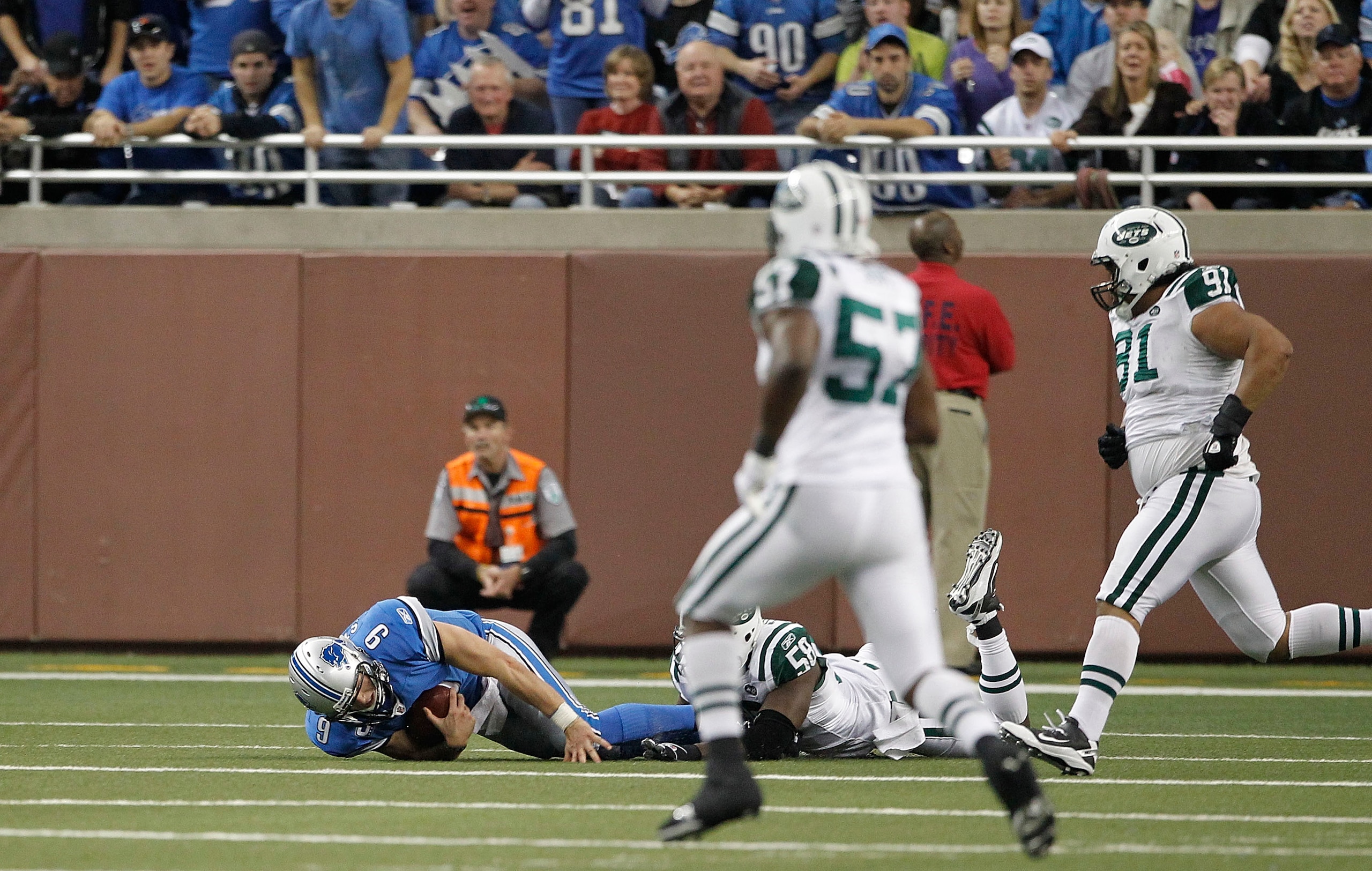 DETROIT - NOVEMBER 07:  Matthew Stafford #9 of the Detroit Lions lays on the ground after being sacked by Bryan Thomas #58 of the New York Jets during the third quarter of the game at Ford Field on November 7, 2010 in Detroit, Michigan. The Jets defeated