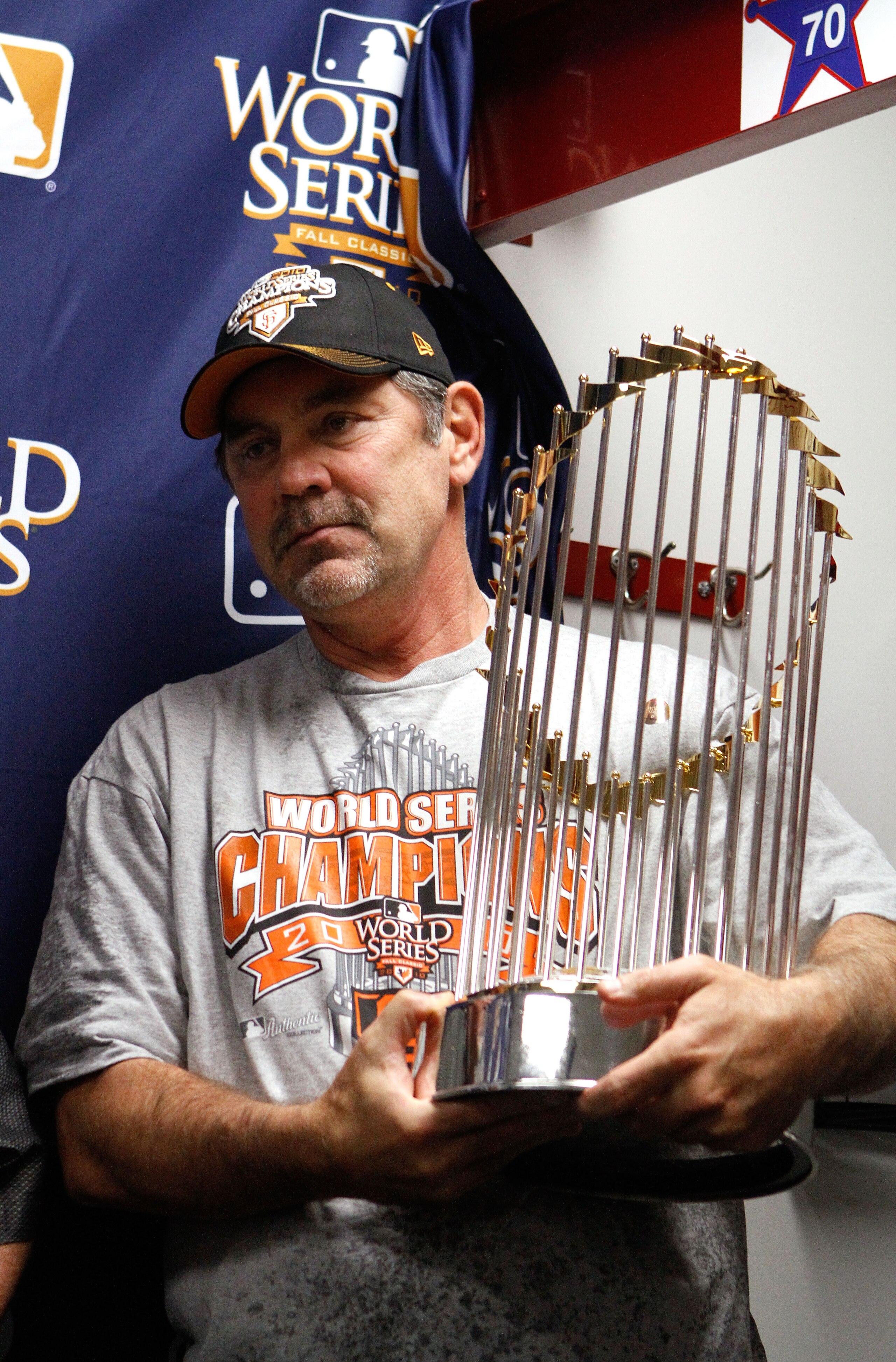 ARLINGTON, TX - NOVEMBER 01: Manager Bruce Bochy of the San Francisco Giants celebrates with the World Series trophy in the locker room after the Giants won 3-1 against the Texas Rangers in Game Five of the 2010 MLB World Series at Rangers Ballpark in Ar ARLINGTON, TX - NOVEMBER 01: Manager Bruce Bochy of the San Francisco Giants celebrates with the World Series trophy in the locker room after the Giants won 3-1 against the Texas Rangers in Game Five of the 2010 MLB World Series at Rangers Ballpark in Ar