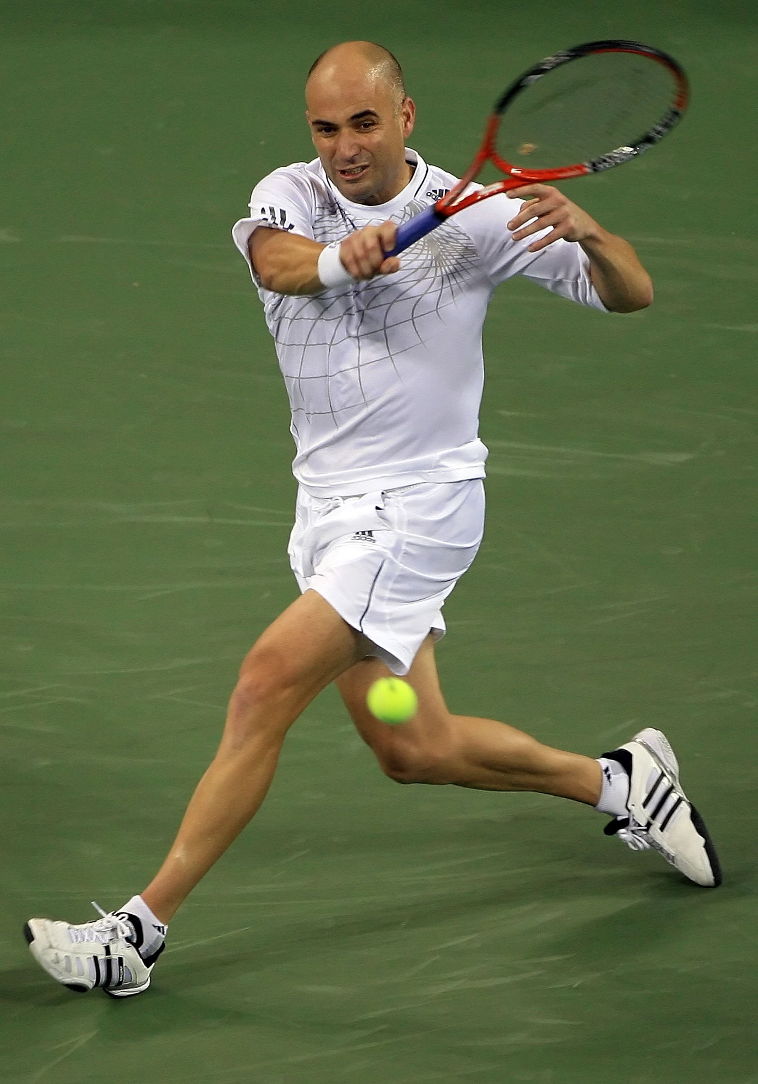 NEW YORK - AUGUST 31:  Andre Agassi returns a forehand to Marcos Baghdatis of Cyprus during the U.S. Open at the USTA Billie Jean King National Tennis Center in Flushing Meadows Corona Park on August 31, 2006 in the Flushing neighborhood of the Queens bor