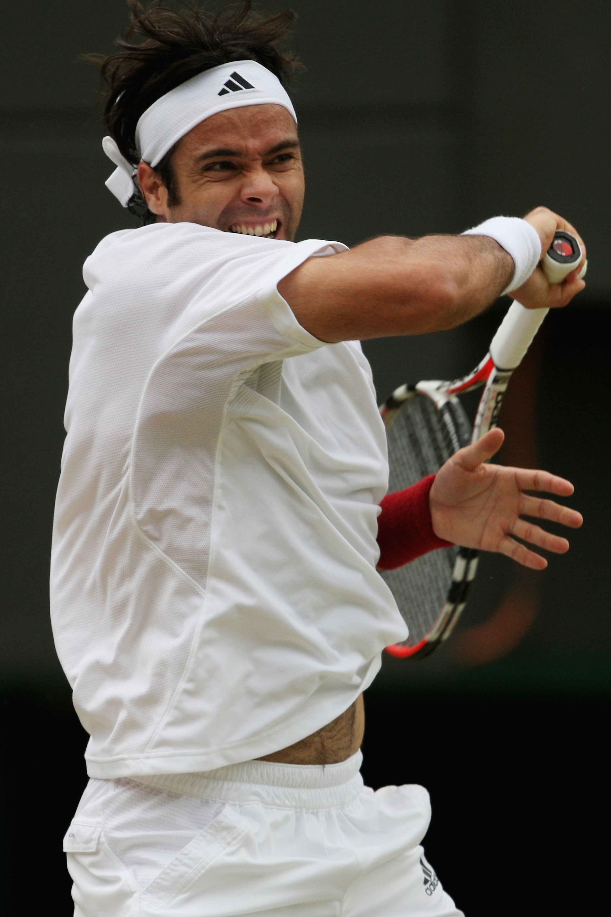 WIMBLEDON, ENGLAND - JUNE 27:  Fernando Gonzalez of Chile plays a forehand during the men's singles third round match against Juan Carlos Ferrero of Spainon Day Six of the Wimbledon Lawn Tennis Championships at the All England Lawn Tennis and Croquet Club