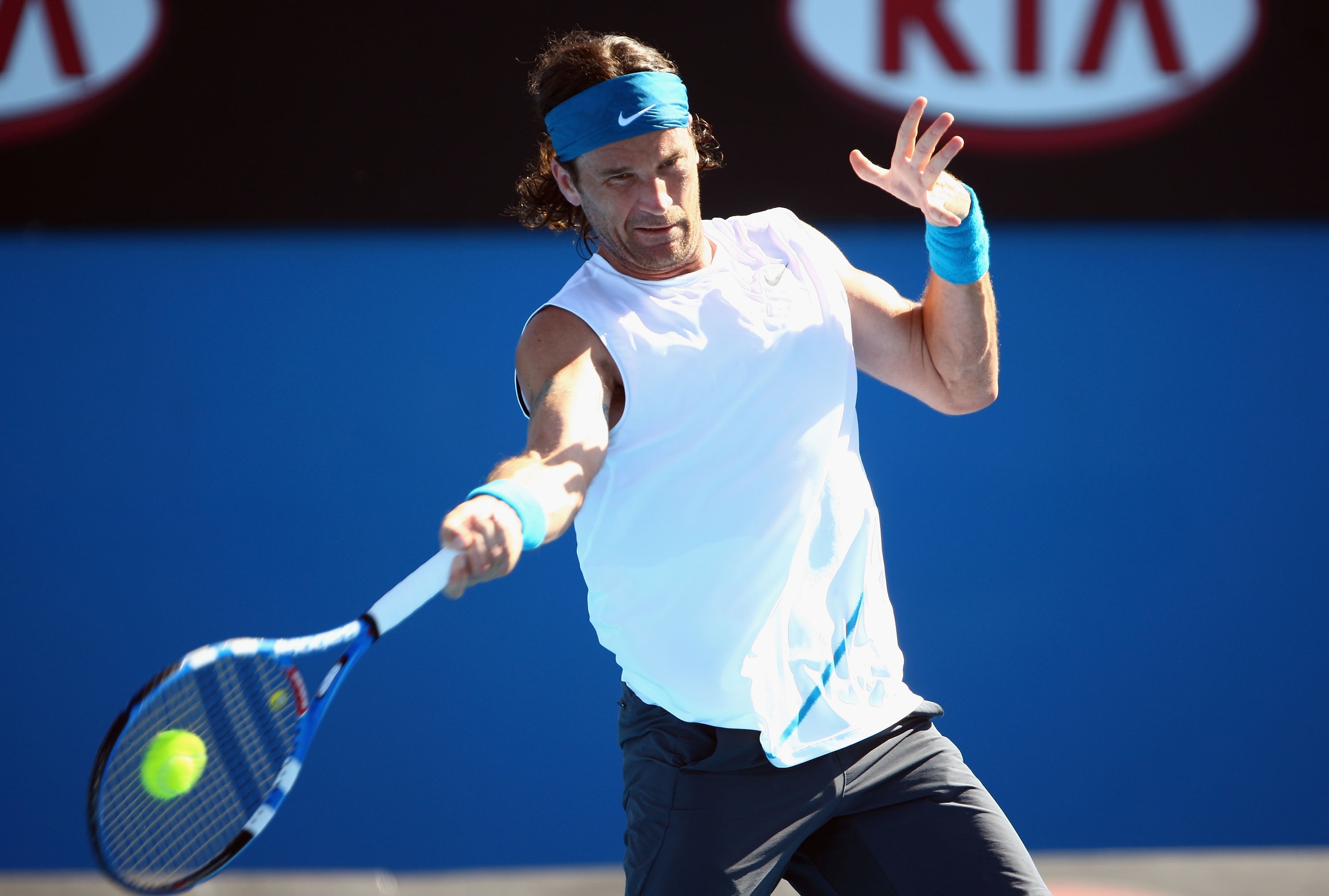 MELBOURNE, AUSTRALIA - JANUARY 19:  Carlos Moya of Spain plays a forehand in his first round match against Evgeny Korolev of Russia during day one of the 2009 Australian Open at Melbourne Park on January 19, 2009 in Melbourne, Australia.  (Photo by Mark K