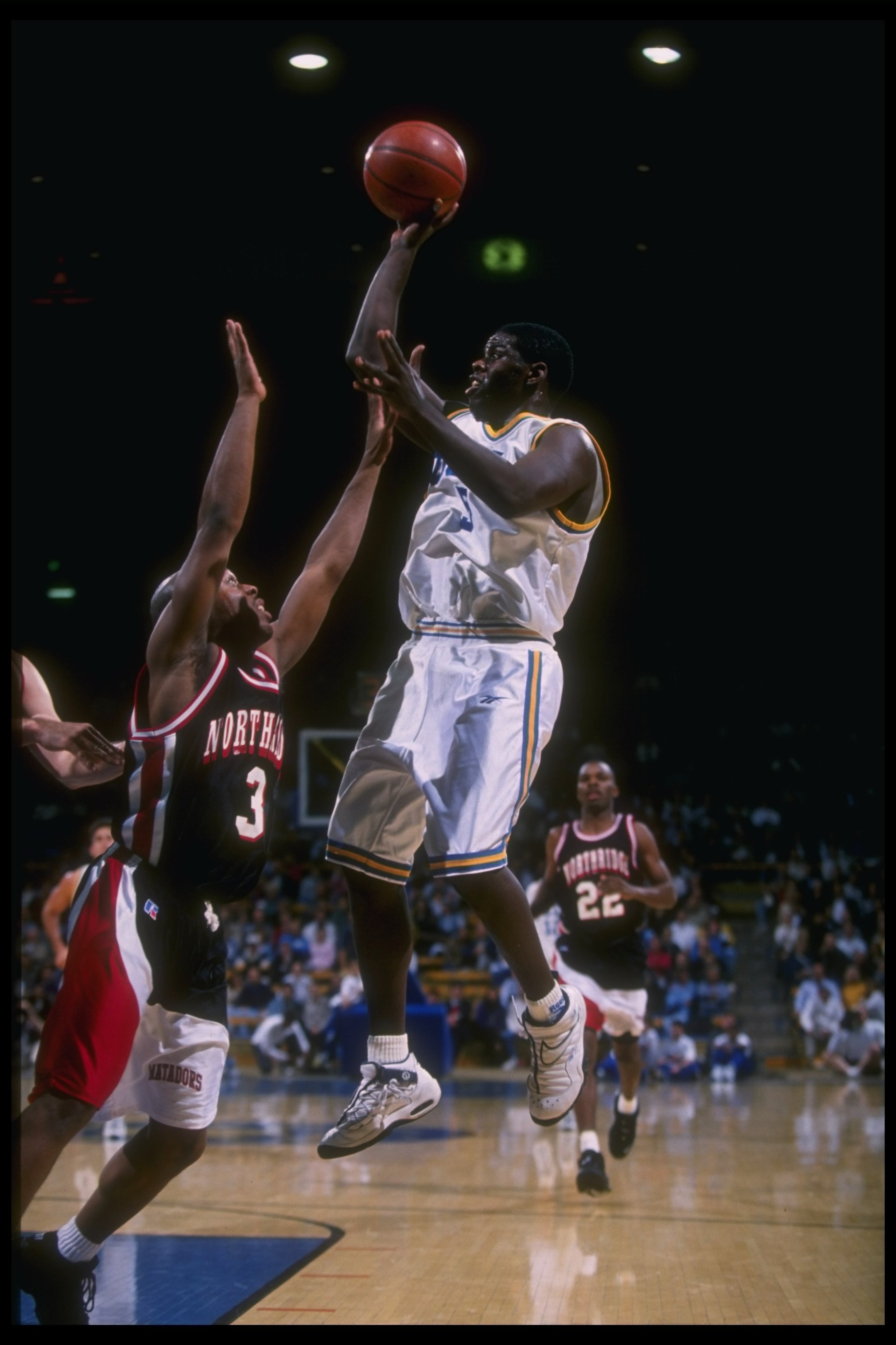 3 Dec 1996:  Guard Cameron Dollar of the UCLA Bruins (right) goes up for two as California State - Northridge Matadors guard Trenton Cross covers him during a game at Pauley Pavilion in Los Angeles, California.  UCLA won the game, 95-73. Mandatory Credit: