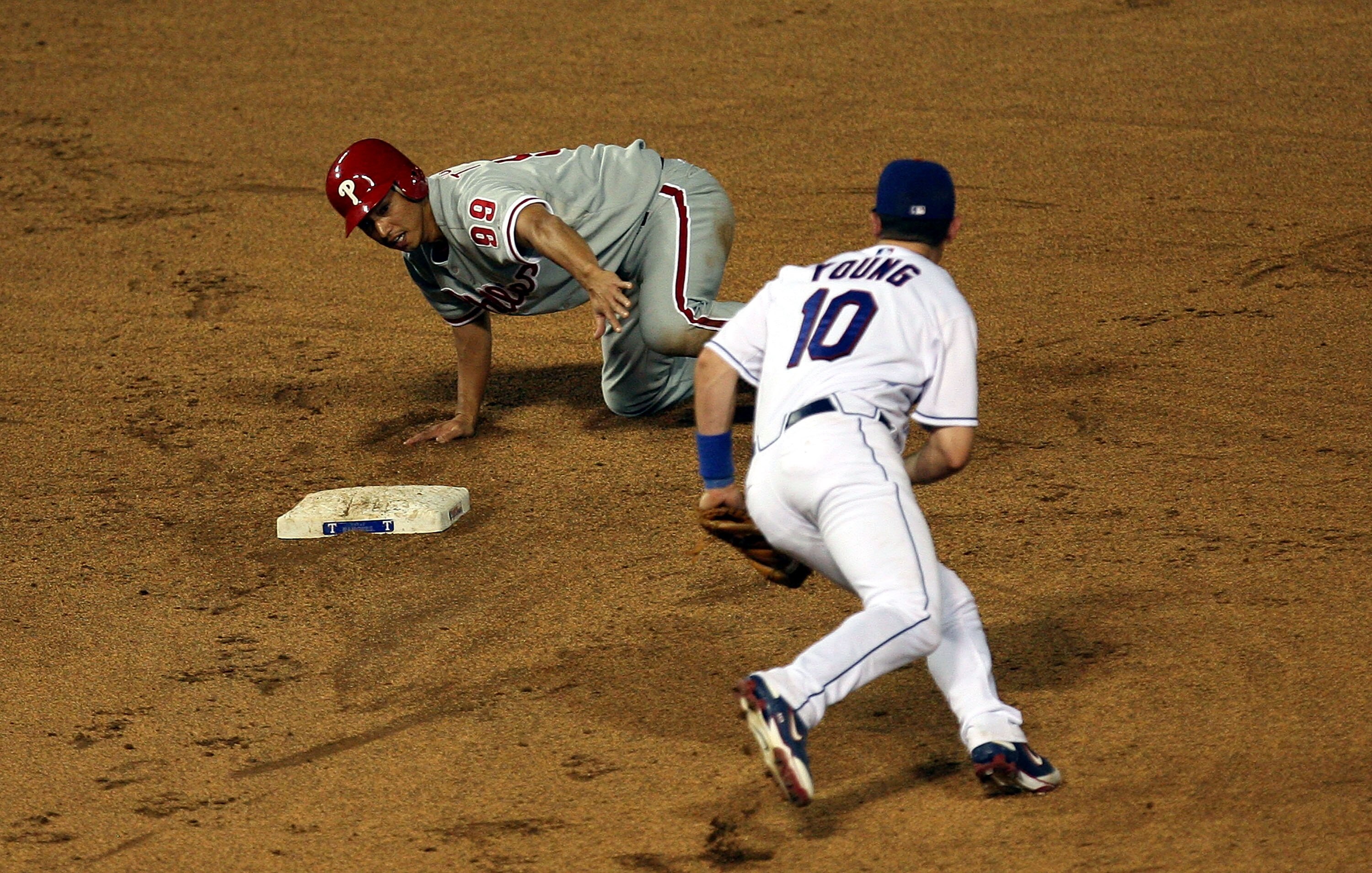 ARLINGTON, TX - JUNE 27:  So Taguchi #99 of the Philadelphia Phillies steals second base against Michael Young #10 of the Texas Rangers during Interleague MLB action on June 27, 2008 at Rangers Ballpark in Arlington, Texas.  (Photo by Ronald Martinez/Gett