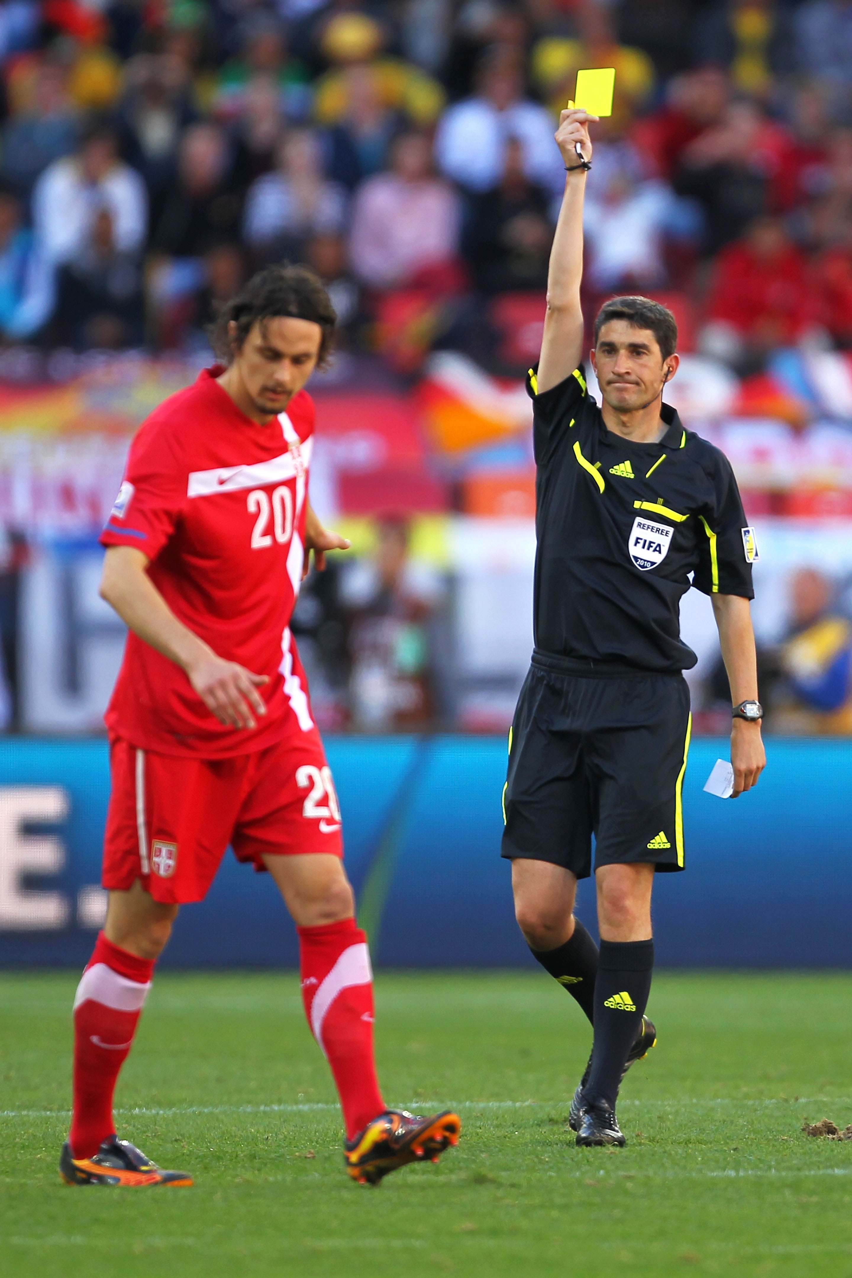 PORT ELIZABETH, SOUTH AFRICA - JUNE 18:  Neven Subotic of Serbia receives a yellow card from Referee Alberto Undiano during the 2010 FIFA World Cup South Africa Group D match between Germany and Serbia at Nelson Mandela Bay Stadium on June 18, 2010 in Por