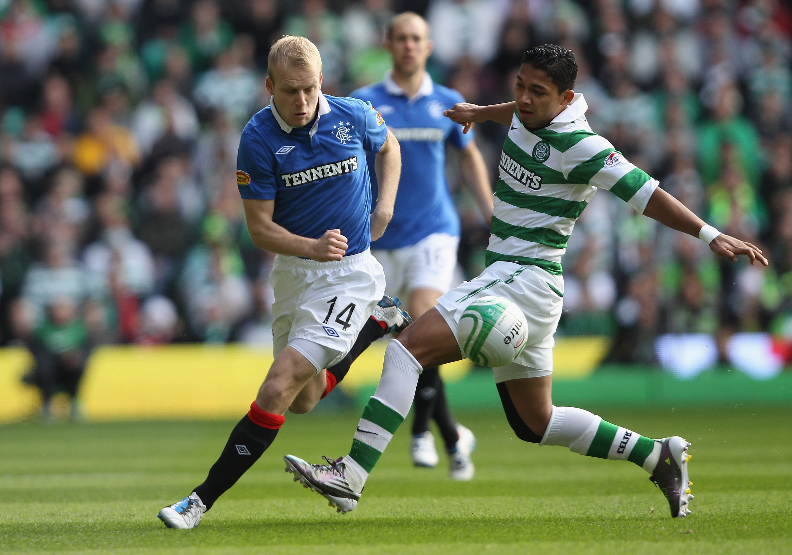 GLASGOW, SCOTLAND - OCTOBER 24: Steven Naismith of Rangers is tackled by Emilio Izaguirre of Celtic during the Clydesdale Bank Premier League match between Celtic and Rangers at Celtic Park on October 24, 2010 in Glasgow, Scotland.  (Photo by Clive Brunsk