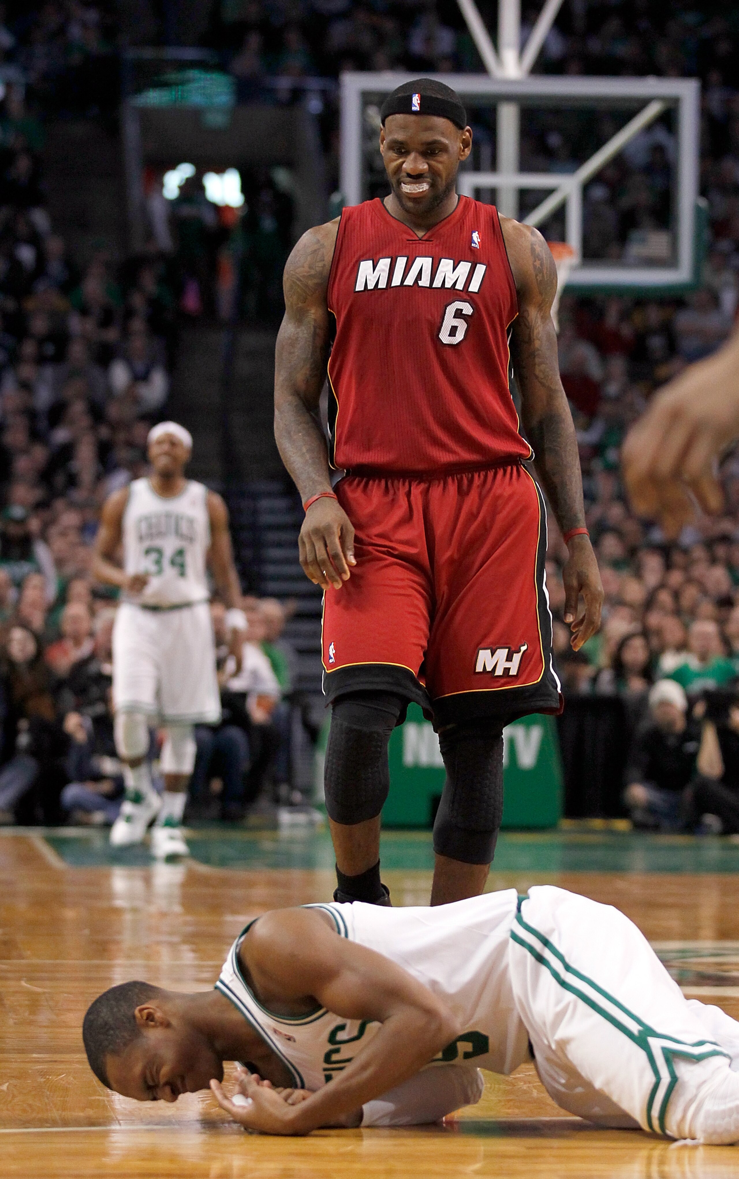 BOSTON - FEBRUARY 13:  LeBron James #6 of the Miami Heat looks at  Rajon Rondo #9 of the Boston Celtics after Rondo fell to the floor at TD Garden on February 13, 2011 in Boston, Massachusetts. NOTE TO USER: User expressly acknowledges and agrees that, by