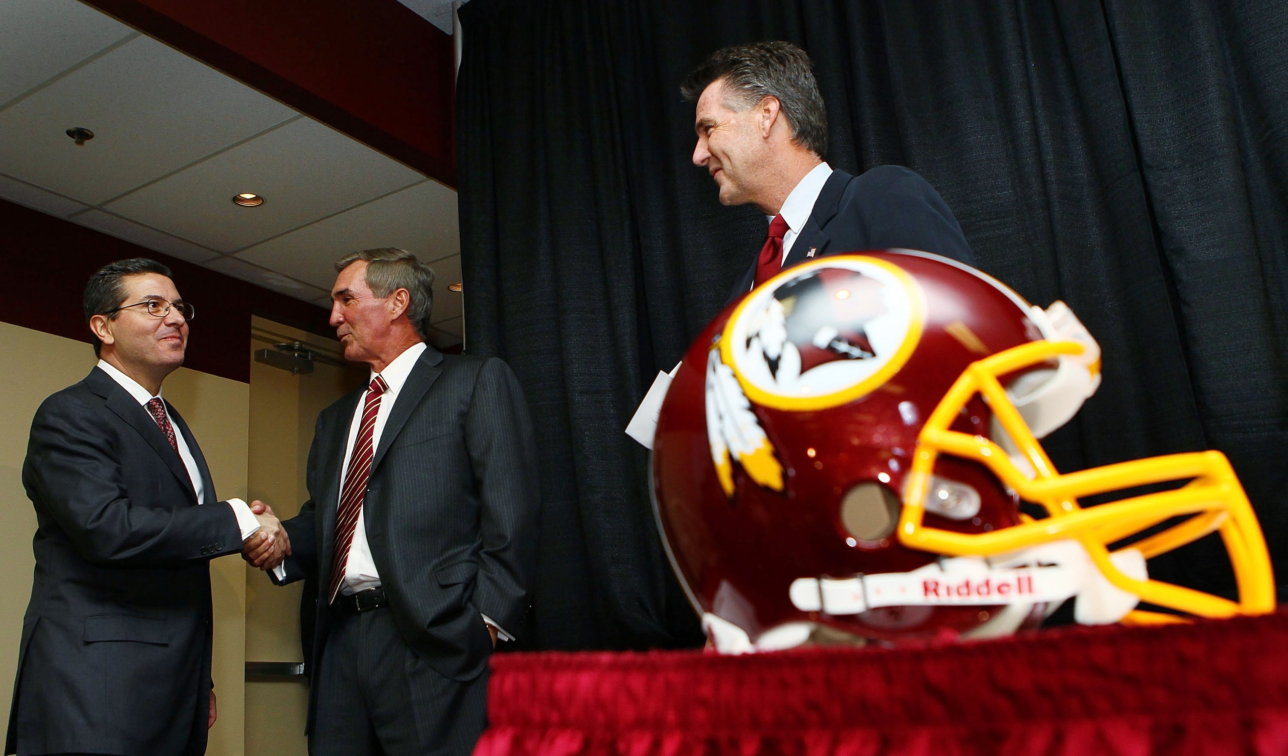 ASHBURN, VA - JANUARY 06: Mike Shanahan (C) shakes hands with Washington Redskins owner Daniel Snyder (L) as General Manager Bruce Allen (R) looks on before Shanahan was announced as the new head coach of the Washington Redskins on January 6, 2010 in Ash ASHBURN, VA - JANUARY 06: Mike Shanahan (C) shakes hands with Washington Redskins owner Daniel Snyder (L) as General Manager Bruce Allen (R) looks on before Shanahan was announced as the new head coach of the Washington Redskins on January 6, 2010 in Ash