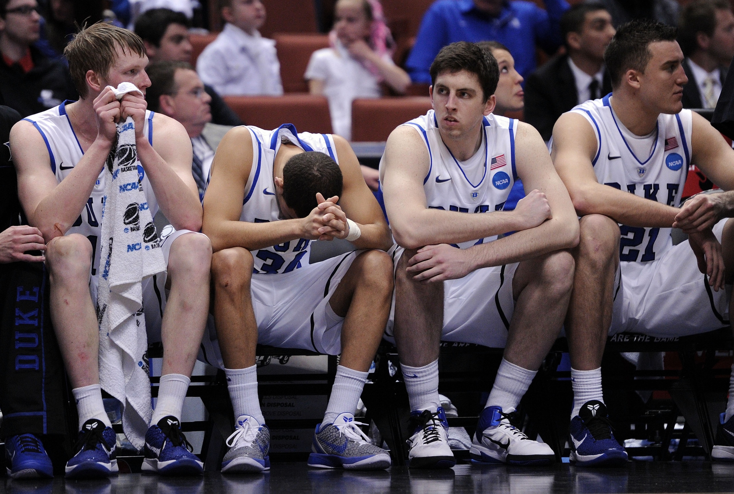 ANAHEIM, CA - MARCH 24:  Kyle Singler #12, Seth Curry #30, Ryan Kelly #34 and Miles Plumlee #21 of the Duke Blue Devils look on from the bench against the Arizona Wildcats during the west regional semifinal of the 2011 NCAA men's basketball tournament at