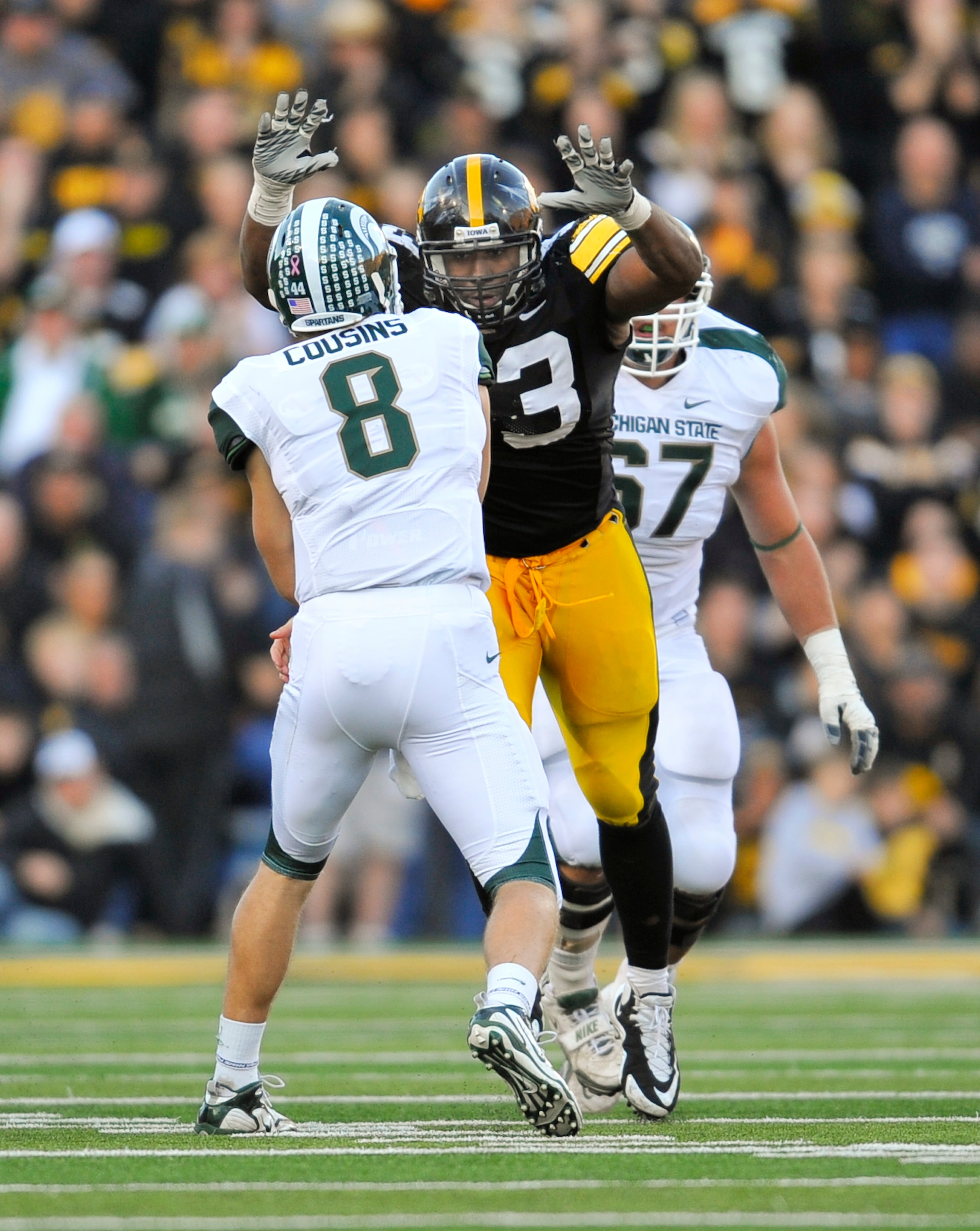 IOWA CITY, IA - OCTOBER 30- Quarterback Kirk Cousins #8 of the Michigan State Spartans throws under pressure from defensive lineman Mike Daniels #93 of the University of Iowa Hawkeyes during the second half of play at Kinnick Stadium on October 30, 2010 i IOWA CITY, IA - OCTOBER 30- Quarterback Kirk Cousins #8 of the Michigan State Spartans throws under pressure from defensive lineman Mike Daniels #93 of the University of Iowa Hawkeyes during the second half of play at Kinnick Stadium on October 30, 2010 i