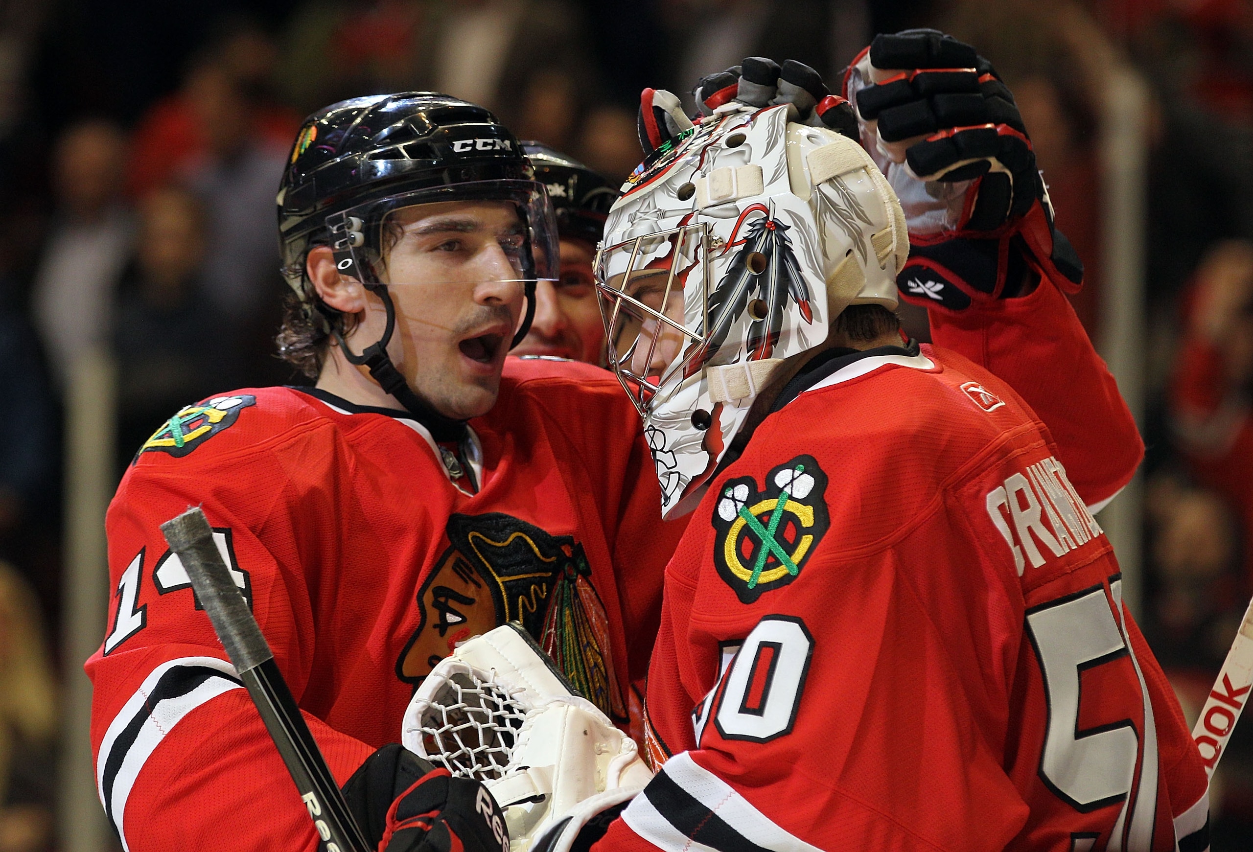 CHICAGO, IL - MARCH 23:  Chris Campoli #14 of the Chicago Blackhawks congratulates Corey Crawford #50 on his 4-0 shutout of the Florida Panthers at the United Center on March 23, 2011 in Chicago, Illinois. The Blackhawks defeated the Panthers 4-0.  (Photo