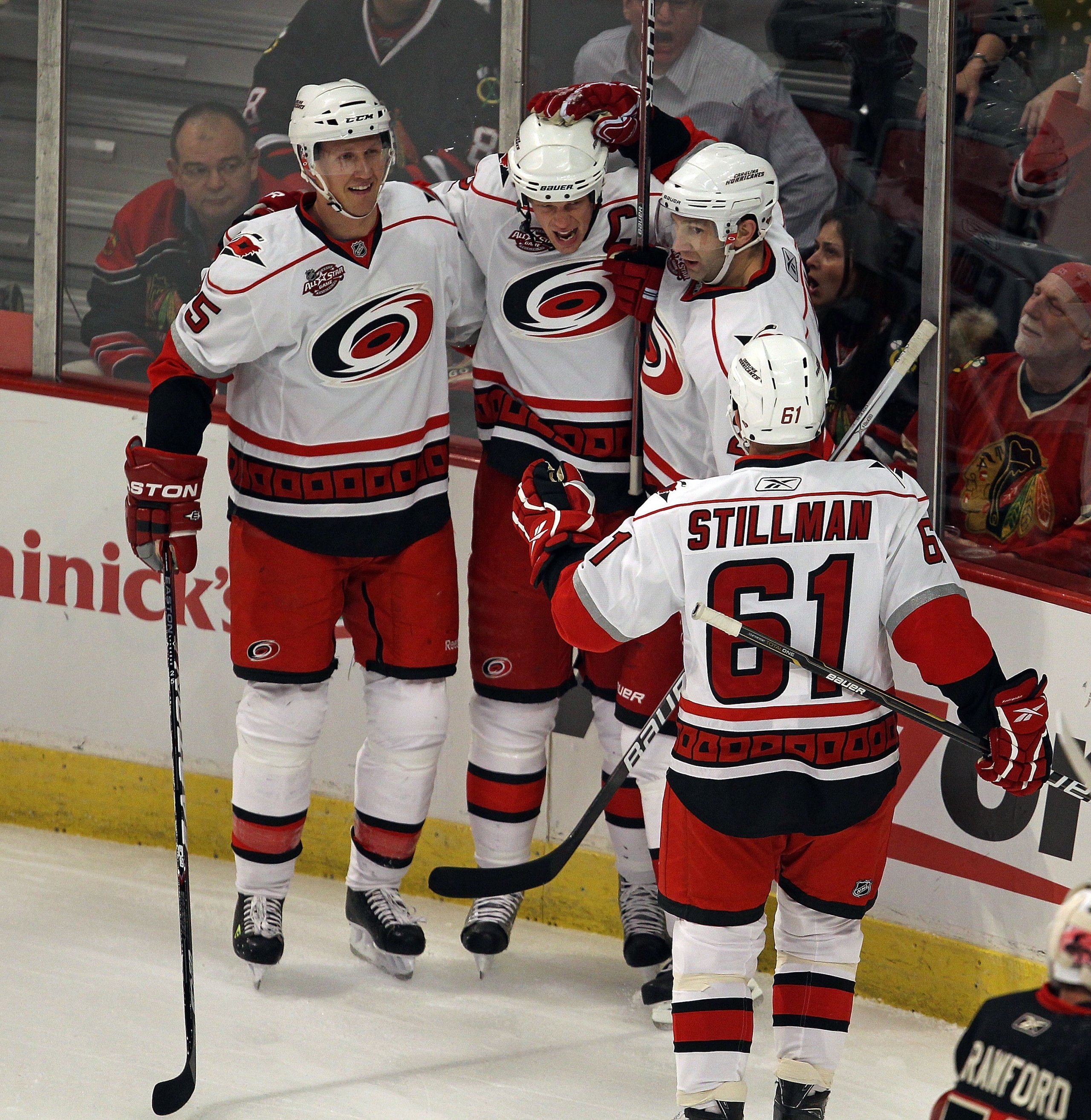 CHICAGO, IL - MARCH 04: (L-R) Bryan Allen #5, Eric Staal #12, Erik Cole #26 and Cory Stillman #61 of the Carolina Hurricanes celebrate a 1st period goal by Staal against the Chicago Blackhawks at the United Center on March 4, 2011 in Chicago, Illinois. (P