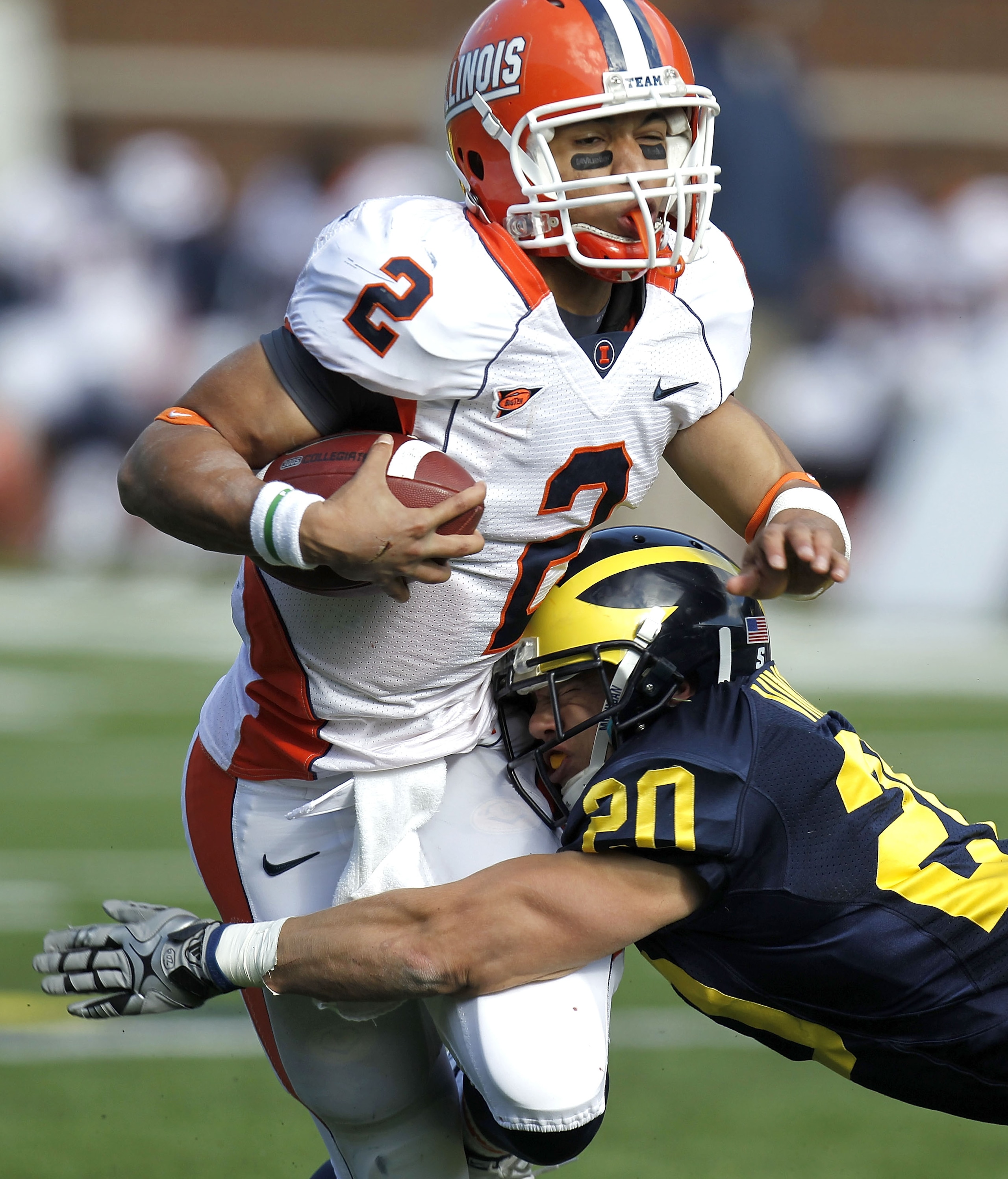 ANN ARBOR, MI - NOVEMBER 06: Nathan Scheelhaase #2 of the Illinios Fighting Illini is tackled by Ray Vinopal #20 of the Michigan Wolverines at Michigan Stadium on November 6, 2010 in Ann Arbor, Michigan. Michigan won the game 67-65. (Photo by Gregory Sh ANN ARBOR, MI - NOVEMBER 06: Nathan Scheelhaase #2 of the Illinios Fighting Illini is tackled by Ray Vinopal #20 of the Michigan Wolverines at Michigan Stadium on November 6, 2010 in Ann Arbor, Michigan. Michigan won the game 67-65. (Photo by Gregory Sh