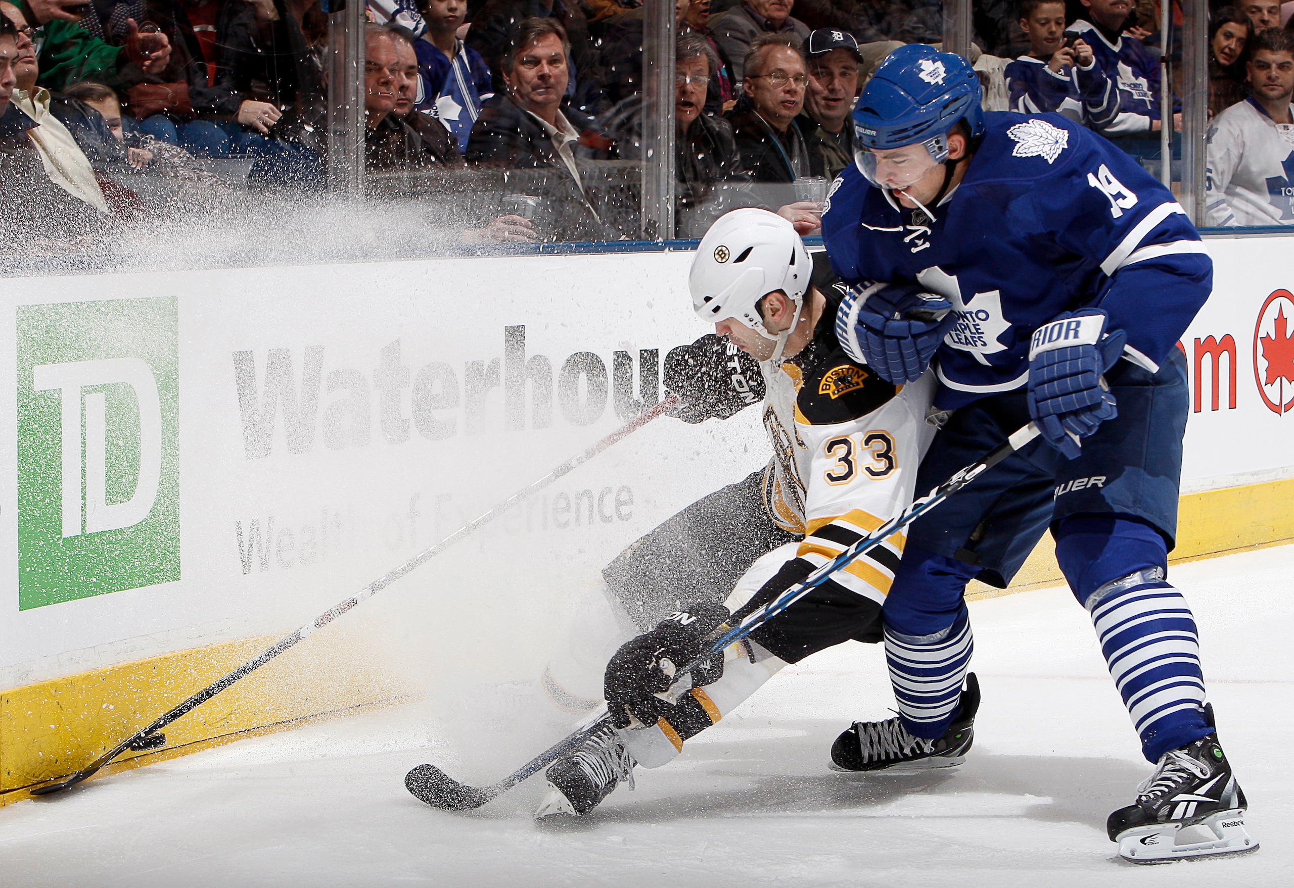 TORONTO, CANADA - MARCH 19  Joffrey Lupul #19 of the Toronto Maple Leafs rubs out Zdeno Chara #33 of the Boston Bruins during game action at the Air Canada Centre March 19, 2011 in Toronto, Ontario, Canada. (Photo by Abelimages/Getty Images)
