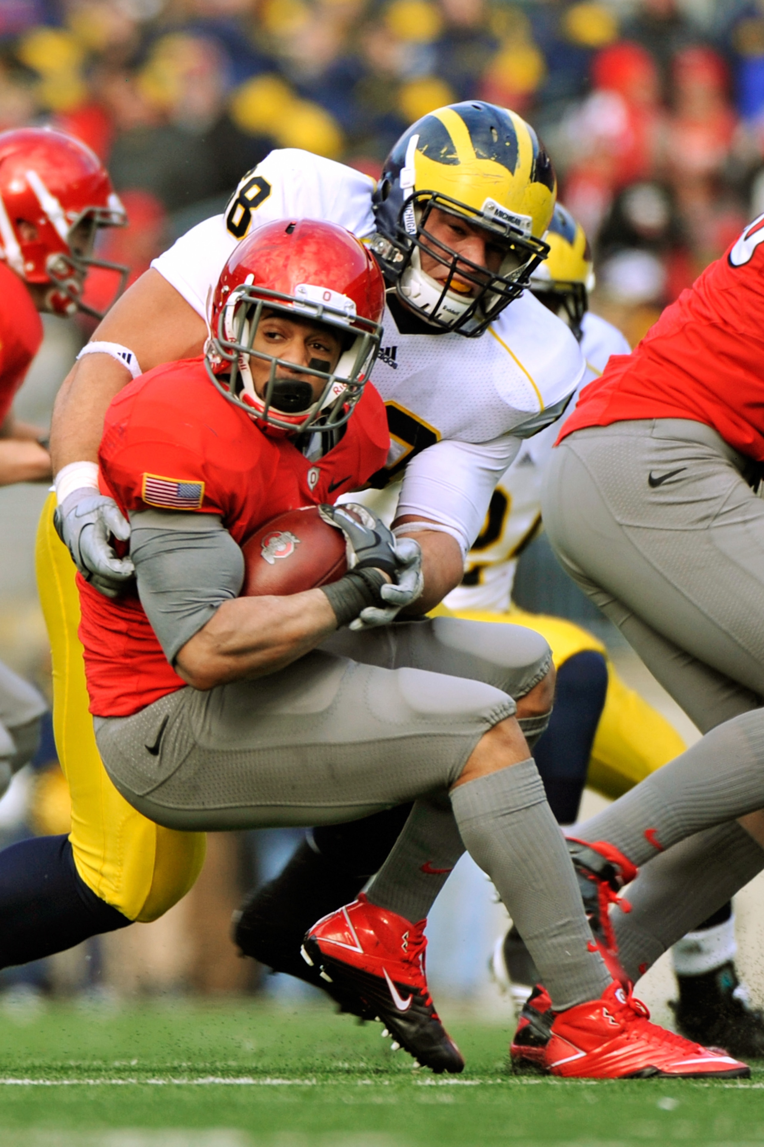 COLUMBUS, OH - NOVEMBER 27: Running back Dan Herron #1 of the Ohio State Buckeyes is wrapped up by Mike Martin #68 of the Michigan Wolverines at Ohio Stadium on November 27, 2010 in Columbus, Ohio. Herron rushed for 175 yards and one touchdown as Ohio St COLUMBUS, OH - NOVEMBER 27: Running back Dan Herron #1 of the Ohio State Buckeyes is wrapped up by Mike Martin #68 of the Michigan Wolverines at Ohio Stadium on November 27, 2010 in Columbus, Ohio. Herron rushed for 175 yards and one touchdown as Ohio St