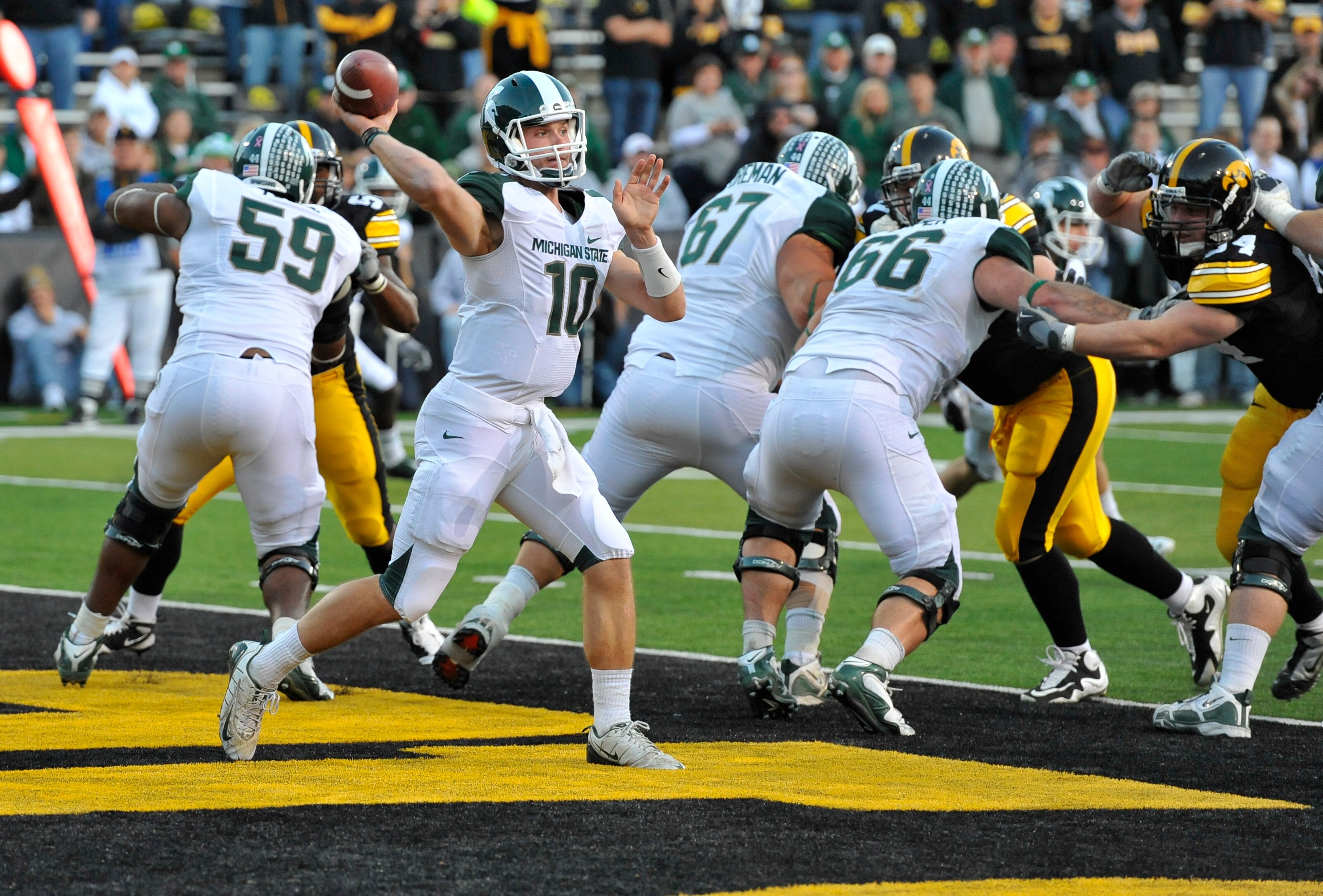 IOWA CITY, IA - OCTOBER 30- Backup Quarterback Andrew Maxwell #10 for the Michigan State Spartans throws under pressure from the Iowa Hawkeyes defense during the second half of play at Kinnick Stadium on October 30, 2010 in Iowa City, Iowa. Iowa won 37-6