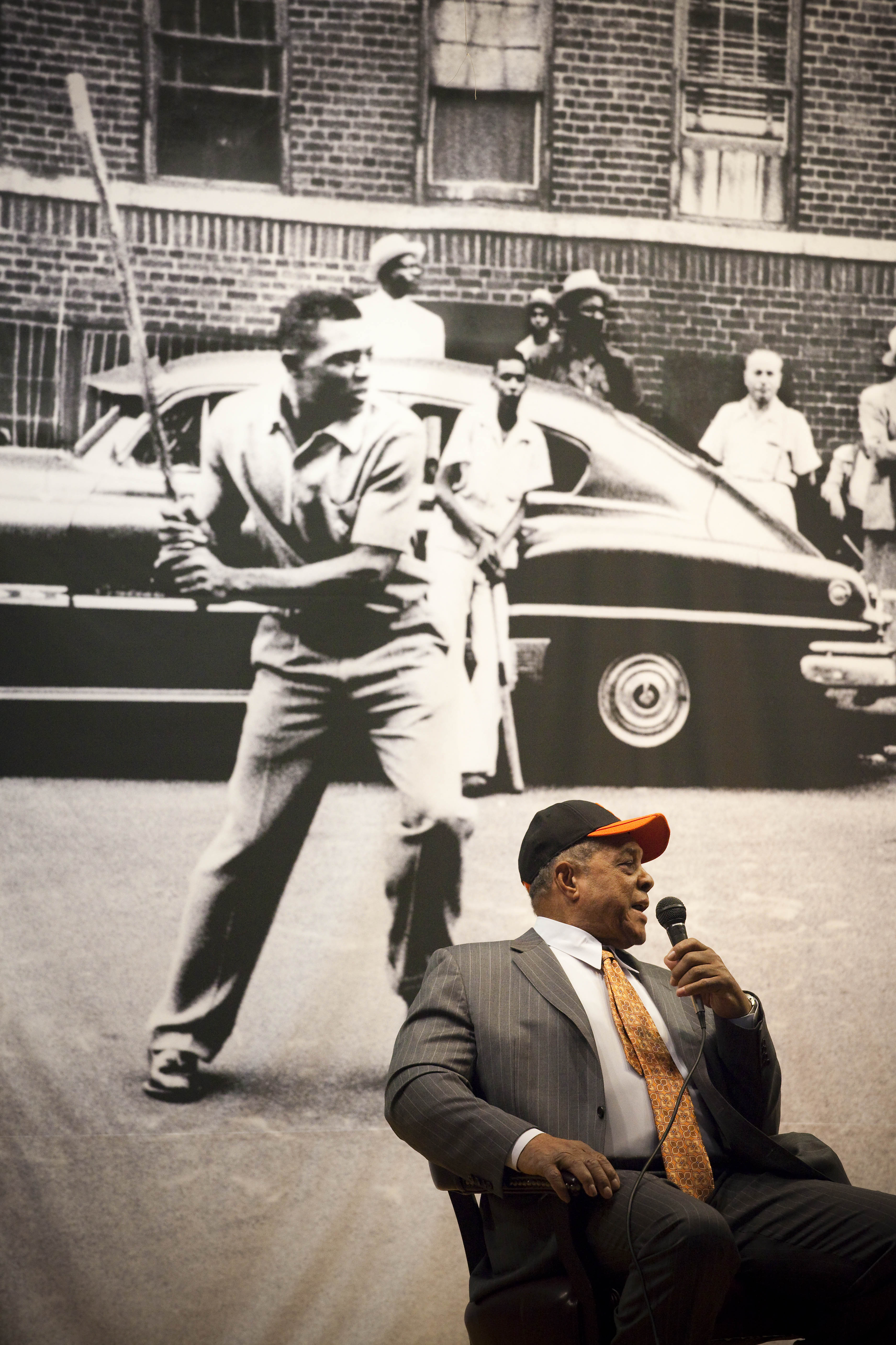 NEW YORK - JANURARY 21:  Sitting in front of a picture of himself playing stickball on the streets of Harlem, Willie Mays is interviewed at PS 46, next to the site of the former Polo Grounds, where the new York Giants played before moving to San Francisco