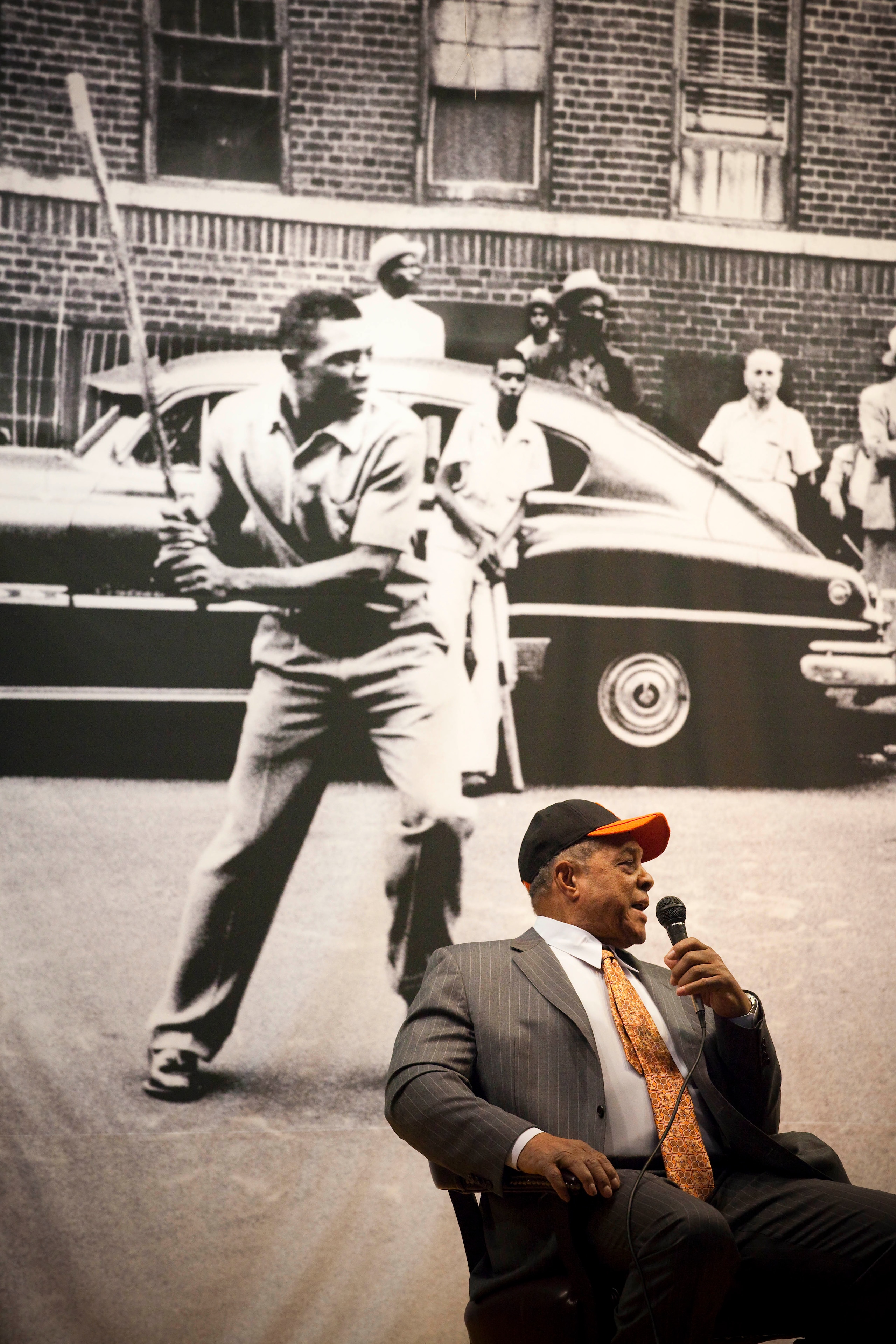 NEW YORK - JANURARY 21: Sitting in front of a picture of himself playing stickball on the streets of Harlem, Willie Mays is interviewed at PS 46, next to the site of the former Polo Grounds, where the new York Giants played before moving to San Francisco NEW YORK - JANURARY 21: Sitting in front of a picture of himself playing stickball on the streets of Harlem, Willie Mays is interviewed at PS 46, next to the site of the former Polo Grounds, where the new York Giants played before moving to San Francisco