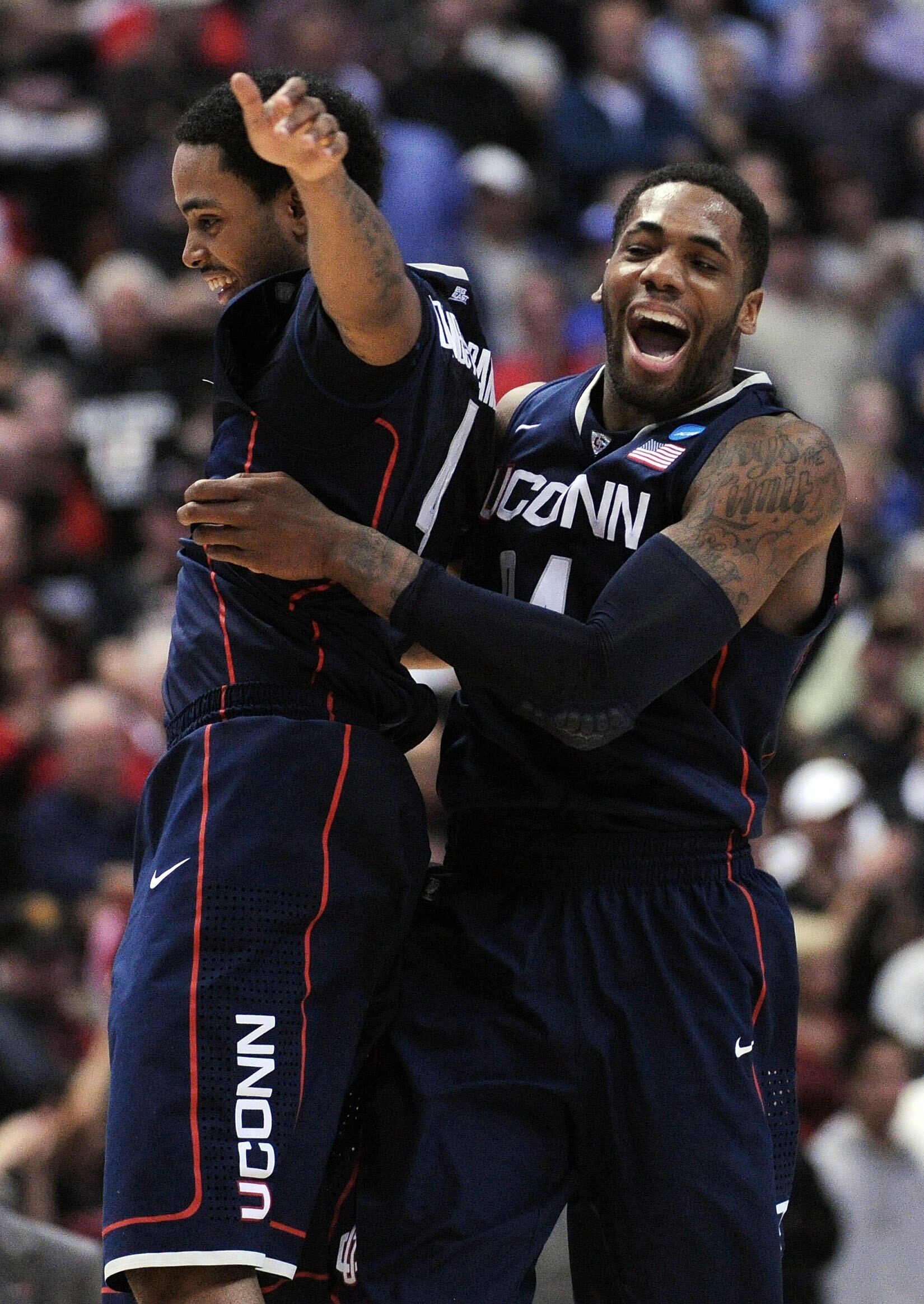 ANAHEIM, CA - MARCH 24:  Jamal Coombs-McDaniel #4 and Alex Oriakhi #34 of the Connecticut Huskies celebrate after defeating the San Diego State Aztecs during the west regional semifinal of the 2011 NCAA men's basketball tournament at the Honda Center on M