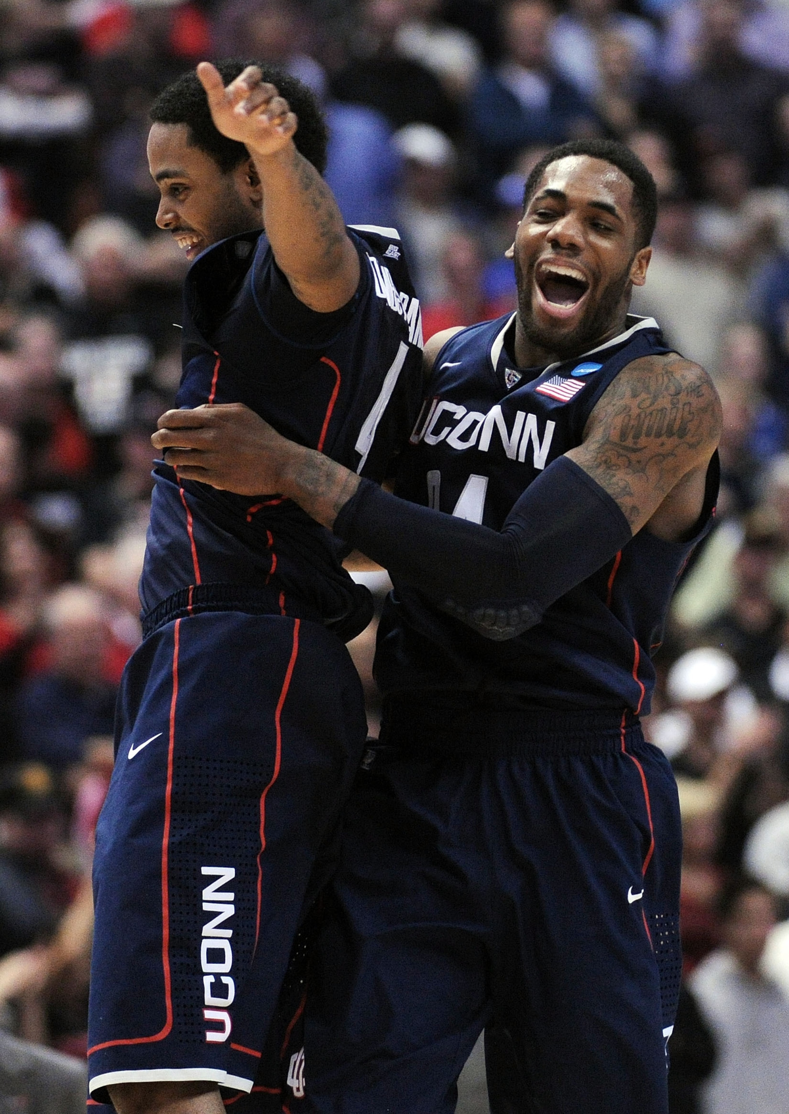 ANAHEIM, CA - MARCH 24:  Jamal Coombs-McDaniel #4 and Alex Oriakhi #34 of the Connecticut Huskies celebrate after defeating the San Diego State Aztecs during the west regional semifinal of the 2011 NCAA men's basketball tournament at the Honda Center on M
