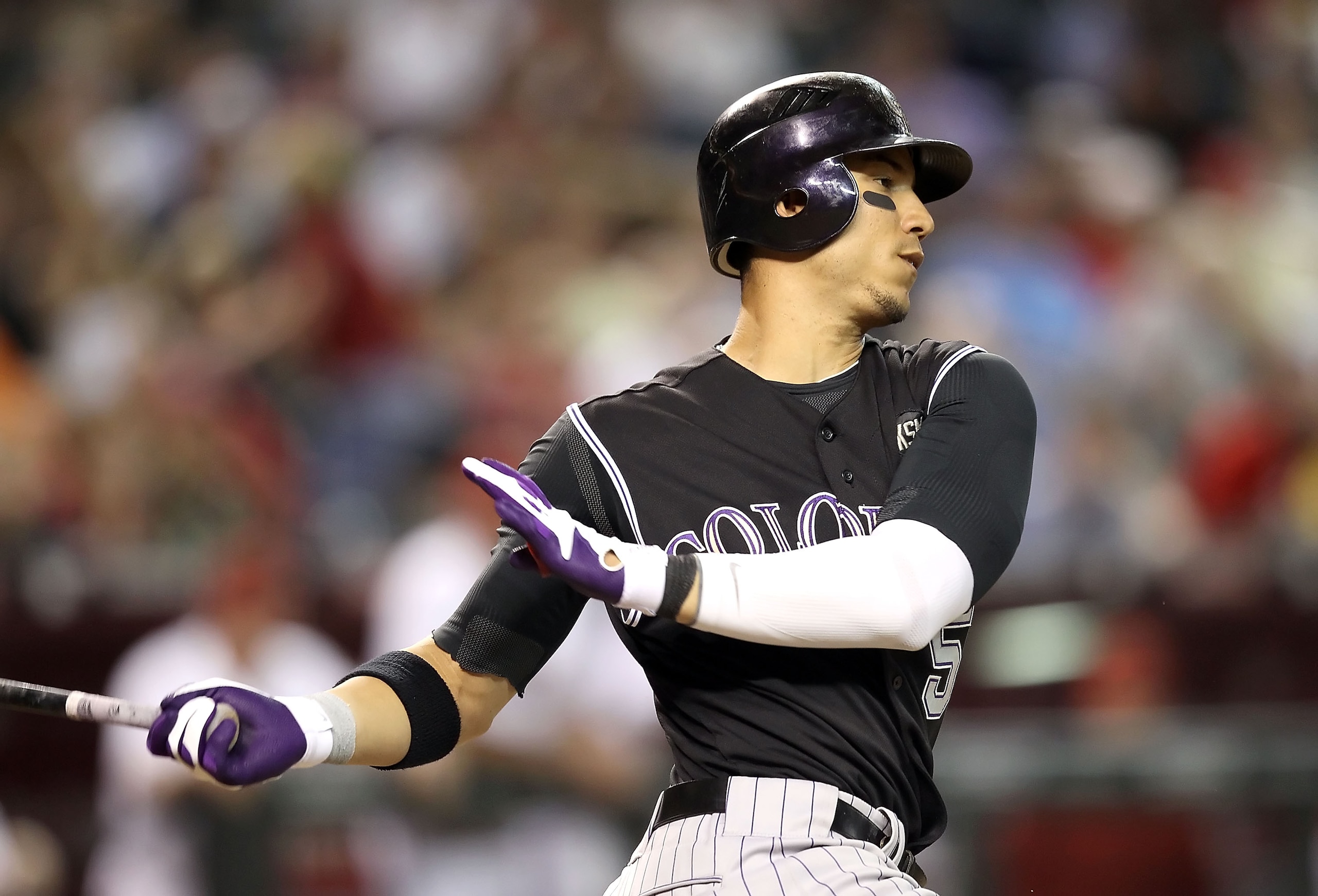 PHOENIX - SEPTEMBER 21:  Carlos Gonzalez #5 of the Colorado Rockies bats against the Arizona Diamondbacks during the Major League Baseball game at Chase Field on September 21, 2010 in Phoenix, Arizona.  (Photo by Christian Petersen/Getty Images)