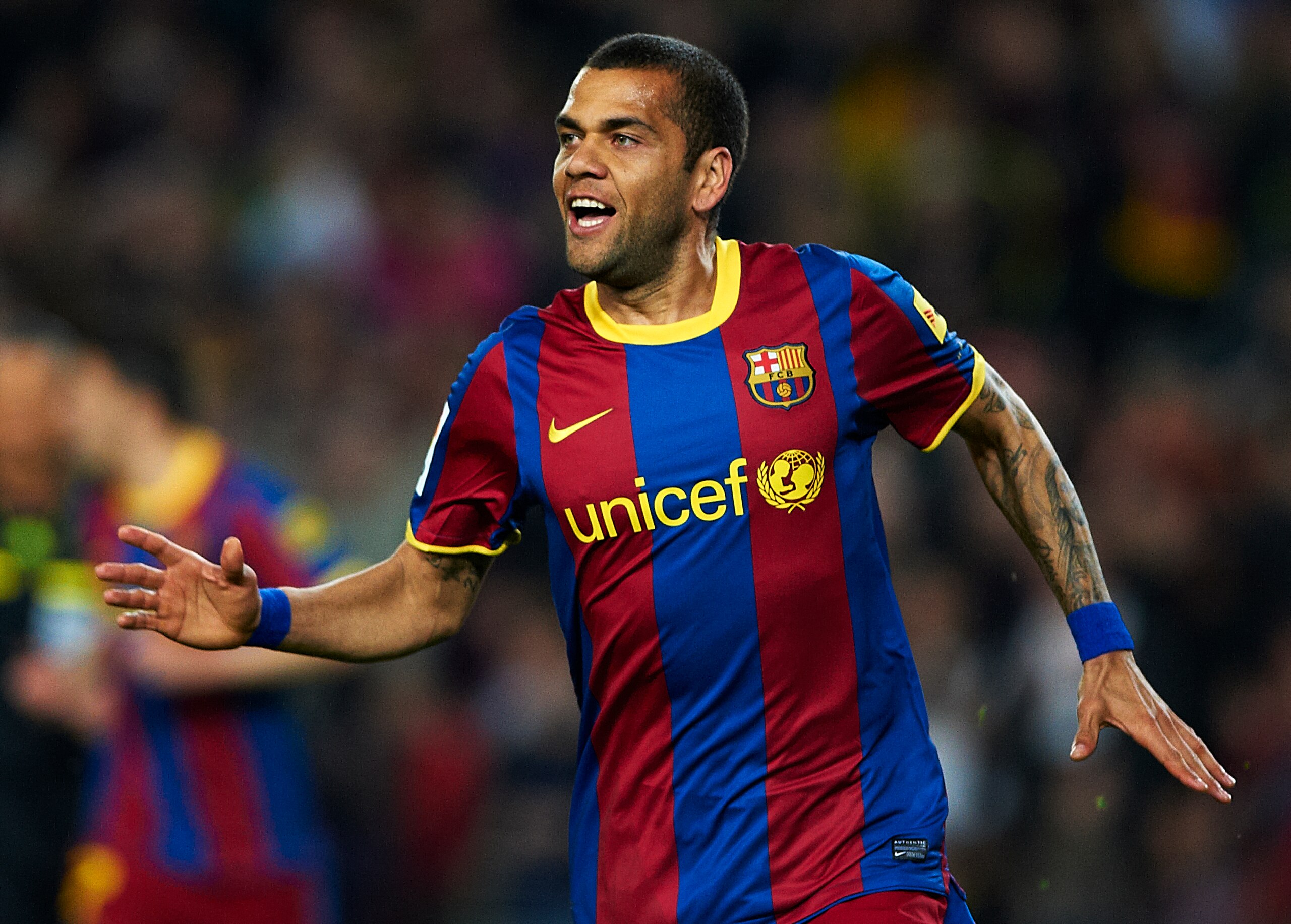 BARCELONA, SPAIN - MARCH 19:  Daniel Alves of Barcelona celebrates after scoring during the La Liga match between Barcelona and Getafe at Camp Nou on March 19, 2011 in Barcelona, Spain. Barcelona won 2-1. (Photo by Manuel Queimadelos Alonso/Getty Images)