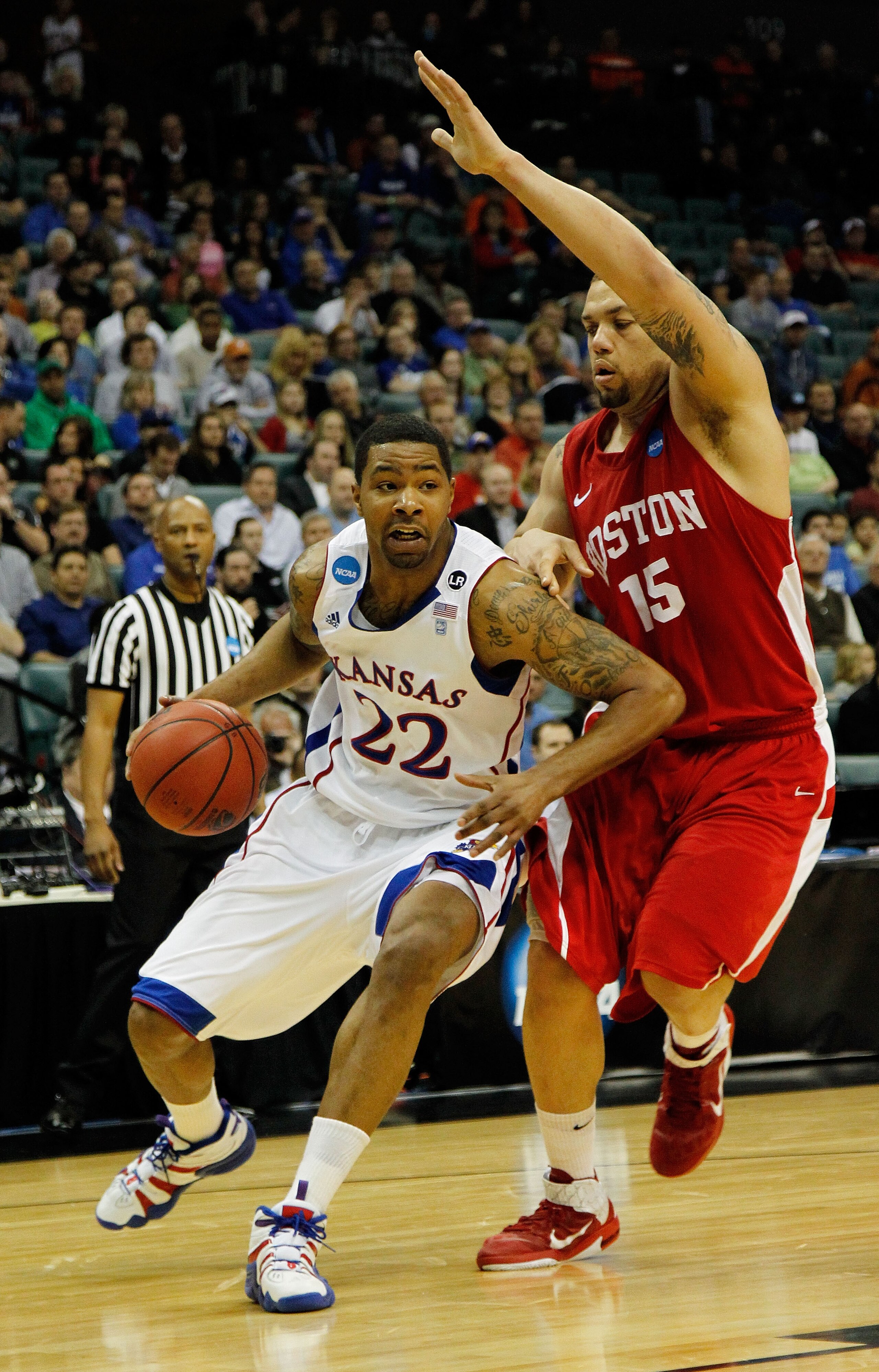 TULSA, OK - MARCH 18:  Marcus Morris #22 of the Kansas Jayhawks drives with the ball against Dom Morris #15 of the Boston University Terriers during the second round of the 2011 NCAA men's basketball tournament at BOK Center on March 18, 2011 in Tulsa, Ok