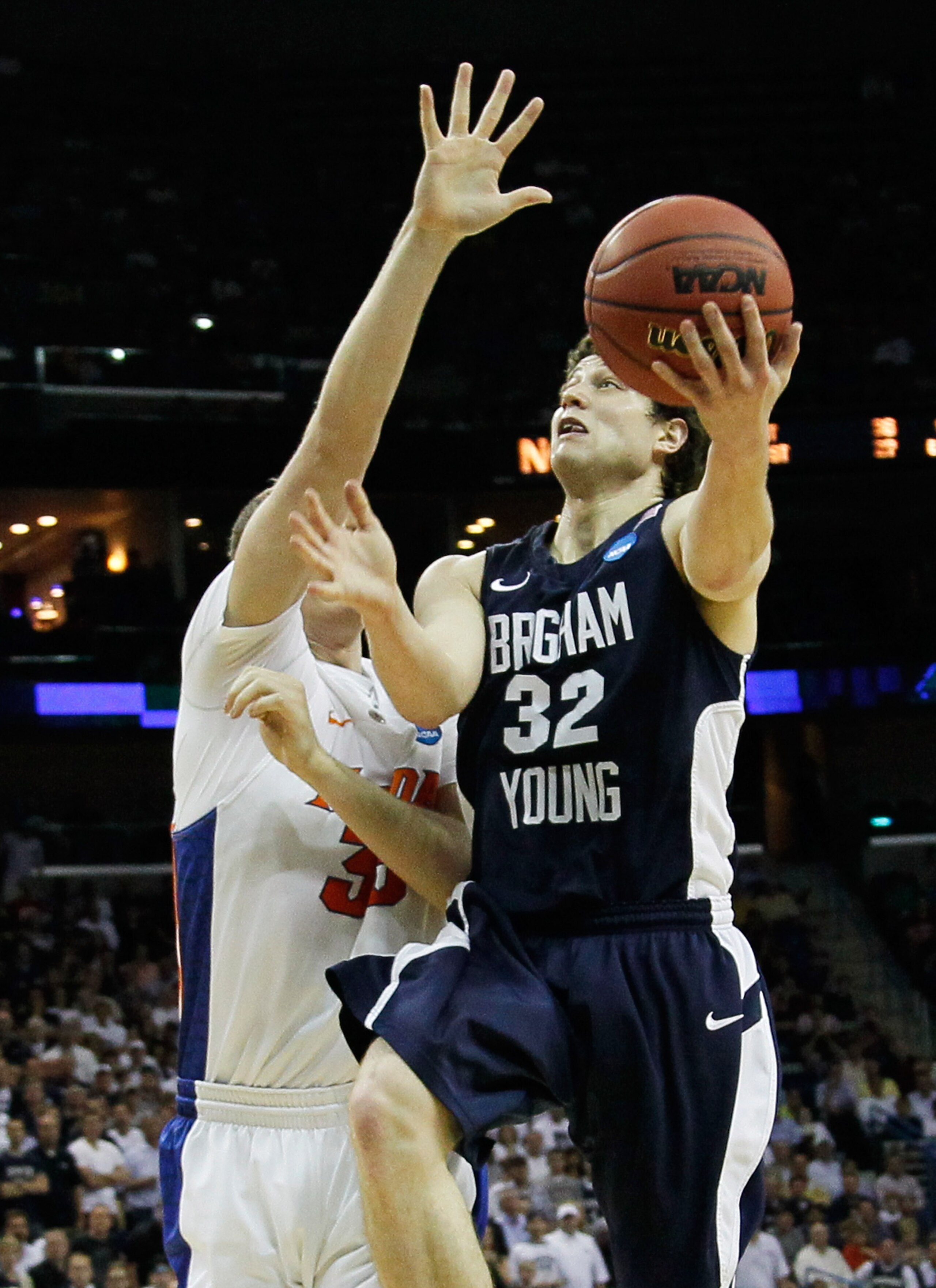 NEW ORLEANS, LA - MARCH 24:  Jimmer Fredette #32 of the Brigham Young Cougars shoots over Erik Murphy #33 of the Florida Gators during the Southeast regional of the 2011 NCAA men's basketball tournament at New Orleans Arena on March 24, 2011 in New Orlean