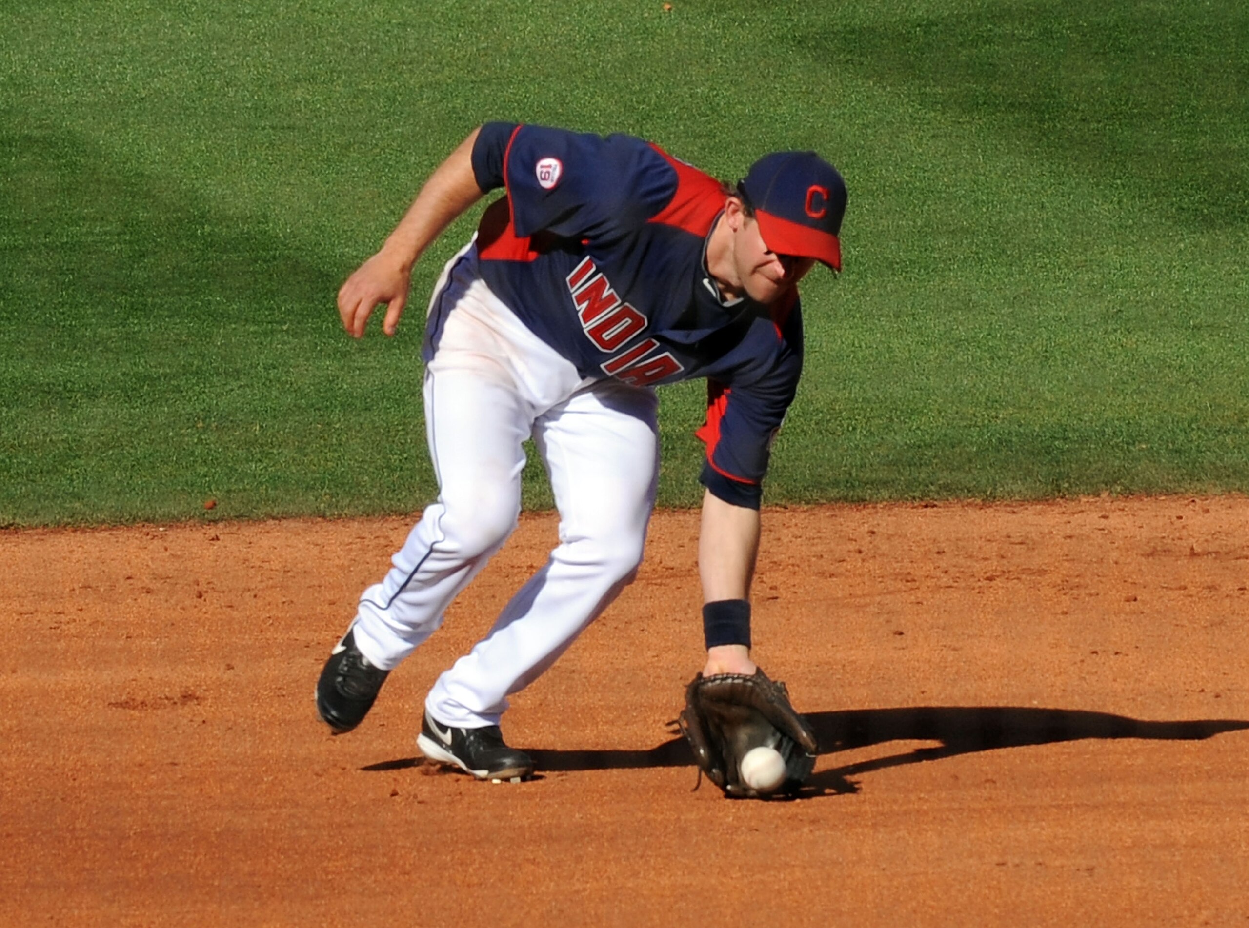 GOODYEAR, AZ - MARCH 11:  Adam Everett #8 of the Cleveland Indians picks up a ground ball against the Seattle Mariners at Goodyear Ballpark on March 11, 2011 in Goodyear, Arizona.  (Photo by Norm Hall/Getty Images)