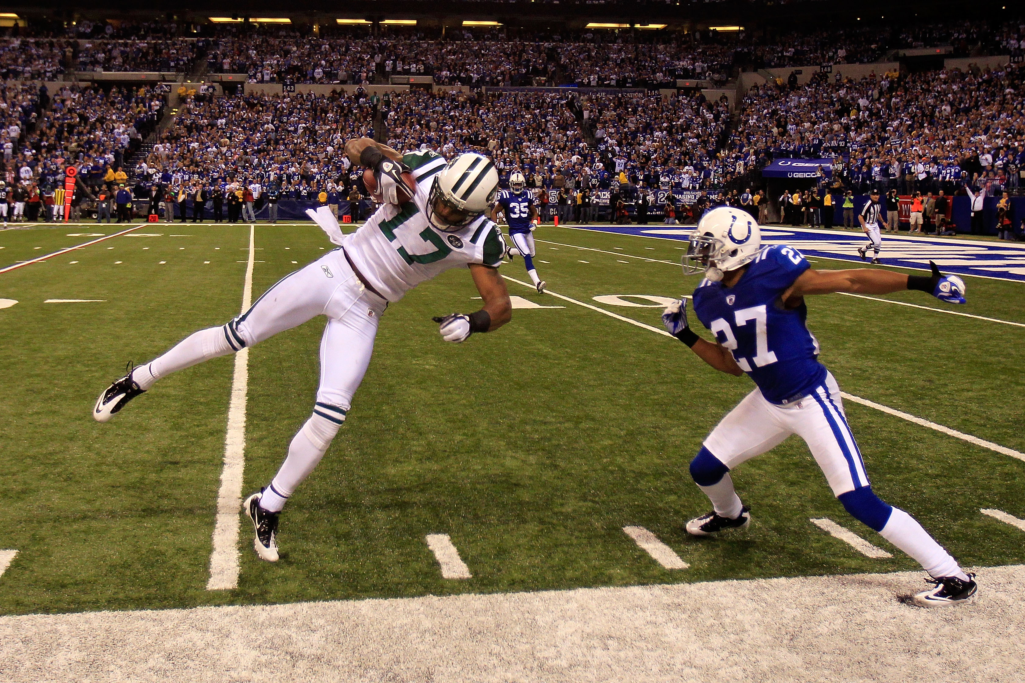 INDIANAPOLIS, IN - JANUARY 08:  Braylon Edwards #17 of the New York Jets makes an 18-yard reception in the final minute of the fourth quarter against Jacob Lacey #27 of the Indianapolis Colts during their 2011 AFC wild card playoff game at Lucas Oil Stadi