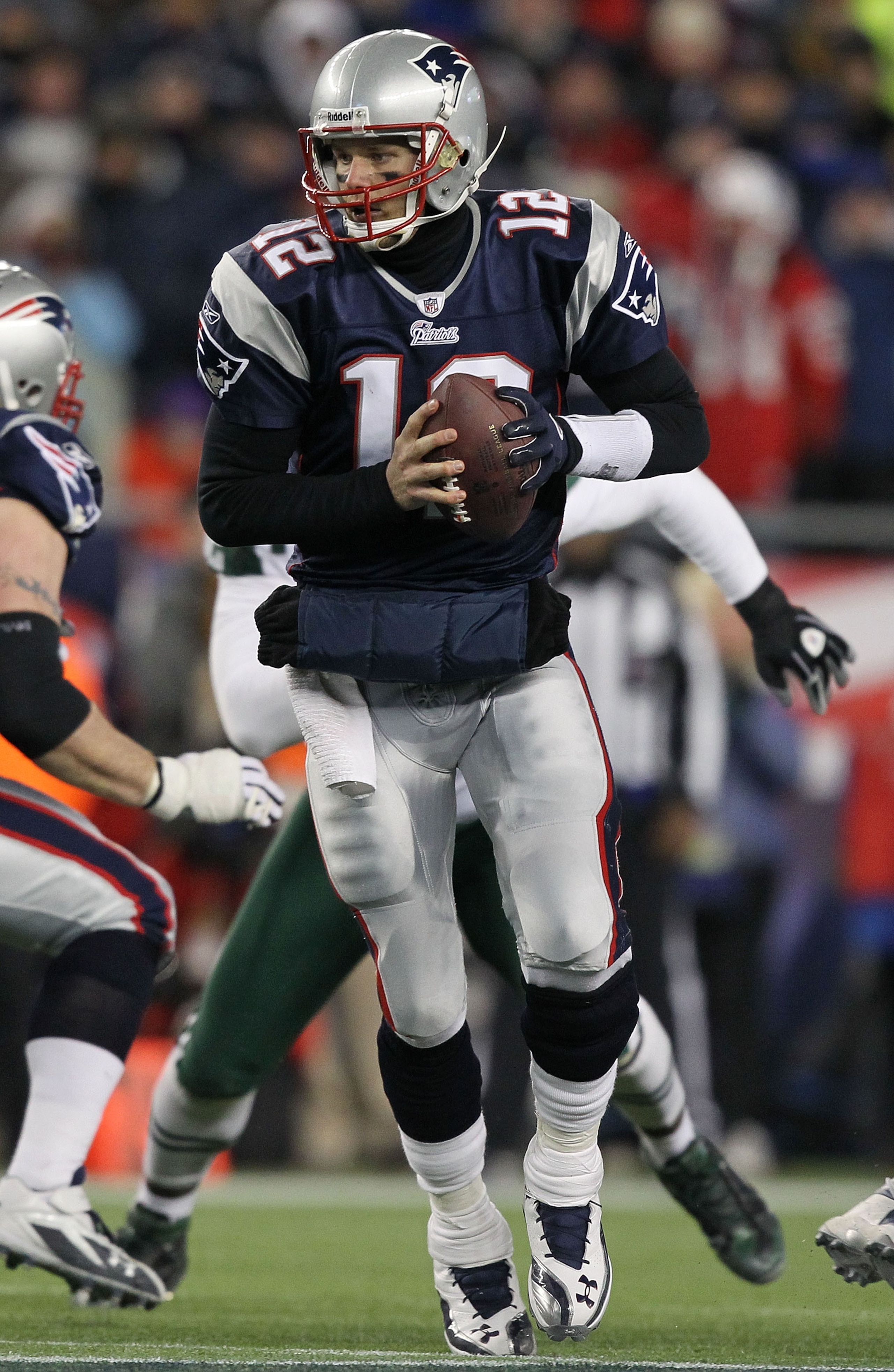 FOXBORO, MA - JANUARY 16:  Quarterback Tom Brady #12 of the New England Patriots drops back with the ball during their 2011 AFC divisional playoff game against the New York Jets at Gillette Stadium on January 16, 2011 in Foxboro, Massachusetts.  (Photo by