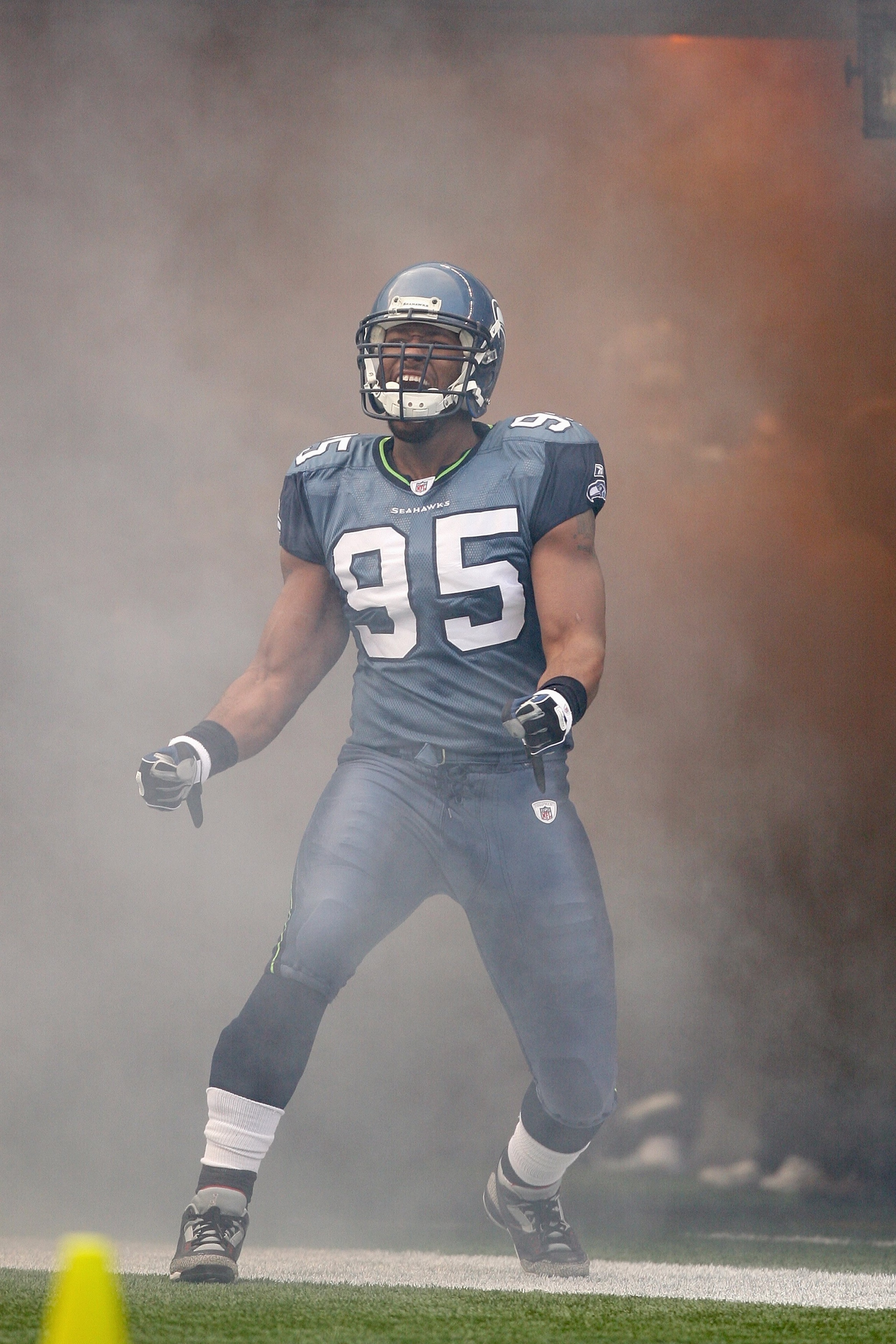 SEATTLE - DECEMBER 07:  Lawrence Jackson #95 of the Seattle Seahawks celebrates as he enters the field before the game against the New England Patriots on December 7, 2008 at Qwest Field in Seattle, Washington. The Patriots defeated the Seahawks 24-21. (P
