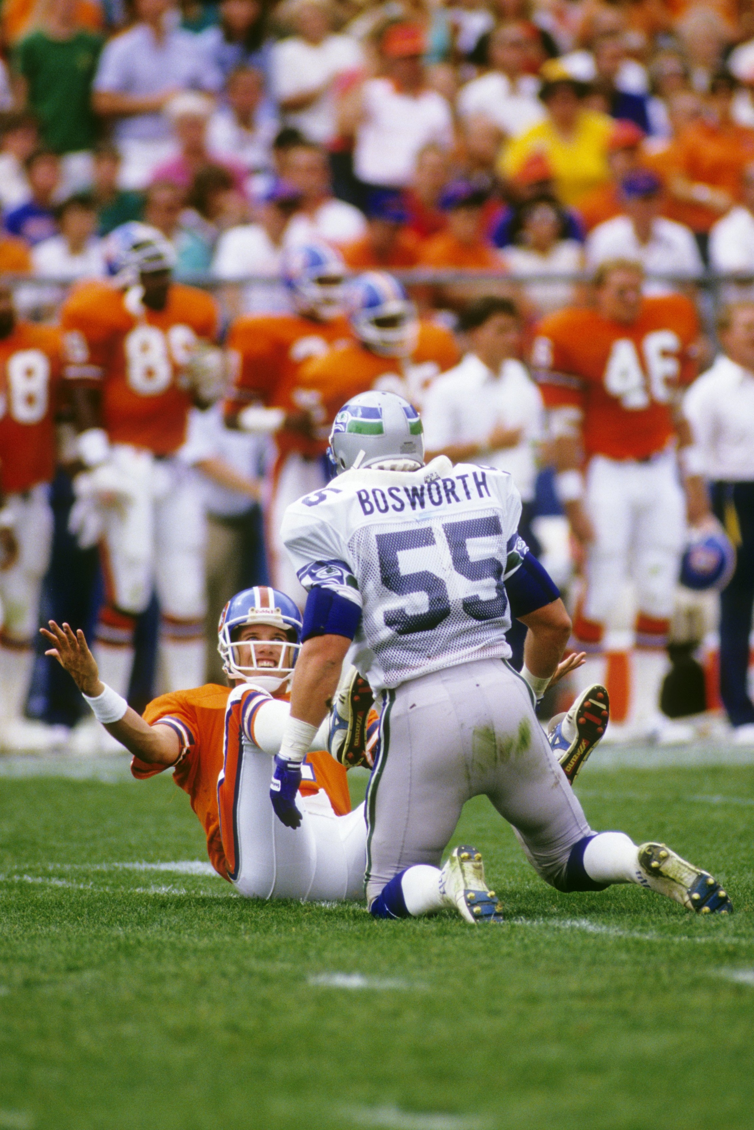 DENVER, CO - SEPTEMBER 13:  Quarterback John Elway #7 of the Denver Broncos taunts linebacker Brian Bosworth #55 of the Seattle Seahawks during the game at Mile High Staduim on September 13, 1987 in Denver, Colorado.  The Broncos won 40-17. (Photo by Geor