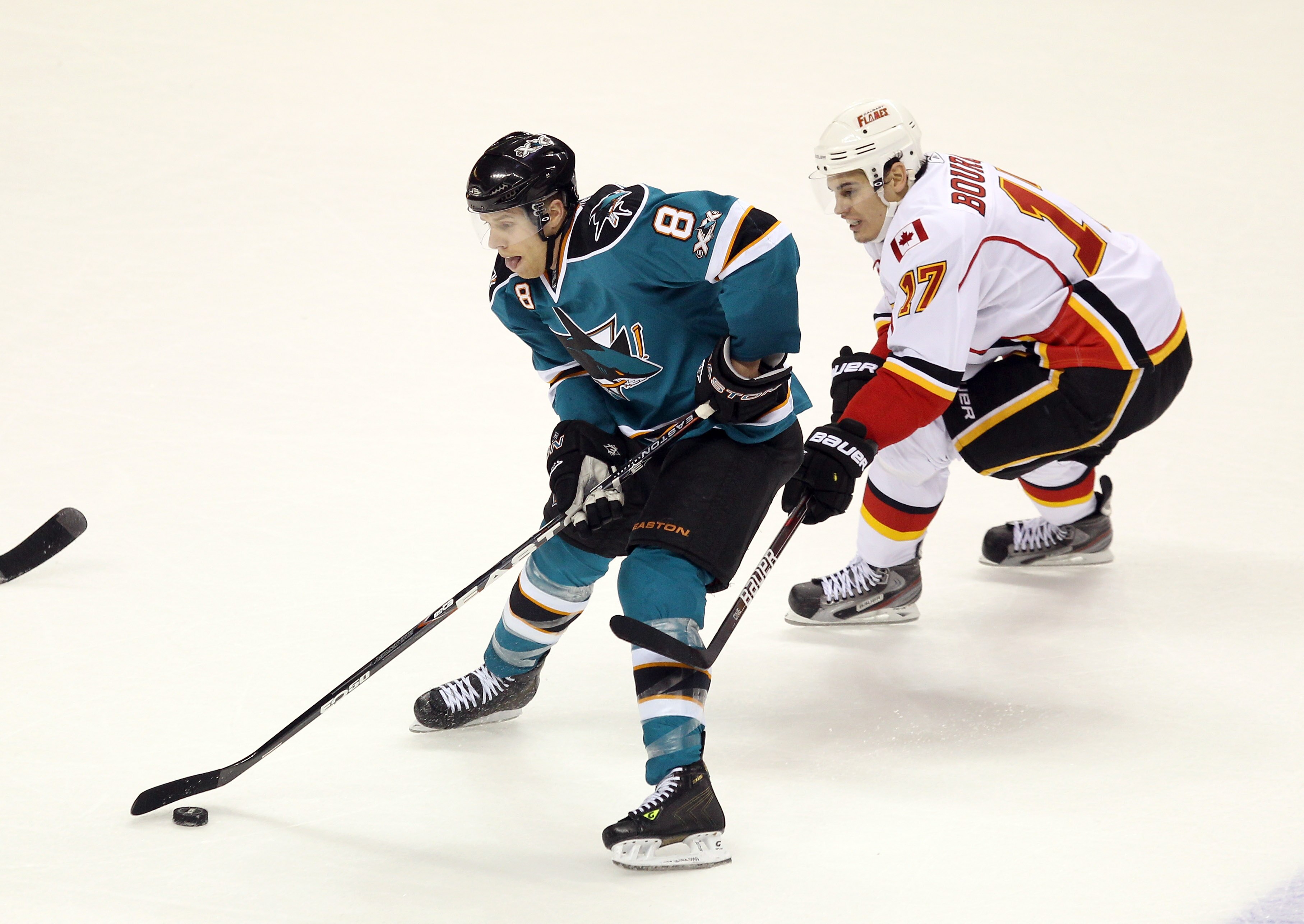 SAN JOSE, CA - MARCH 23: Rene Bourque #17 of the Calgary Flames and Joe Pavelski #8 of the San Jose Sharks go for the puck at the HP Pavilion on March 23, 2011 in San Jose, California.  (Photo by Ezra Shaw/Getty Images)