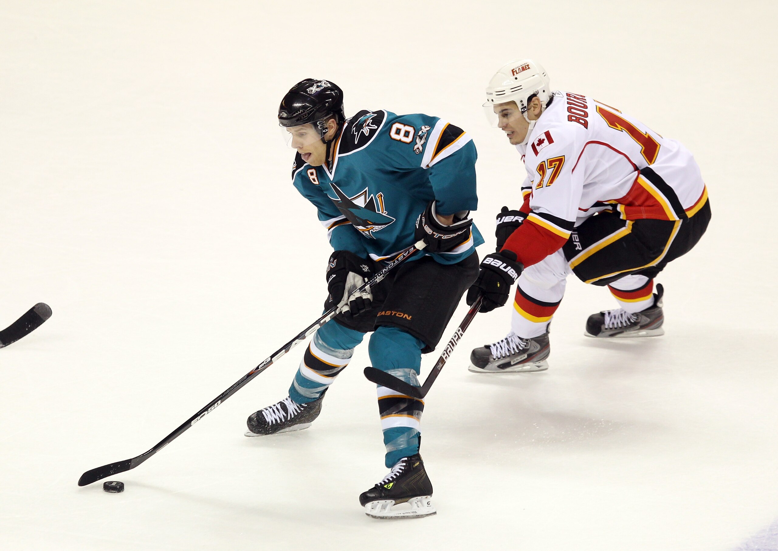 SAN JOSE, CA - MARCH 23: Rene Bourque #17 of the Calgary Flames and Joe Pavelski #8 of the San Jose Sharks go for the puck at the HP Pavilion on March 23, 2011 in San Jose, California.  (Photo by Ezra Shaw/Getty Images)