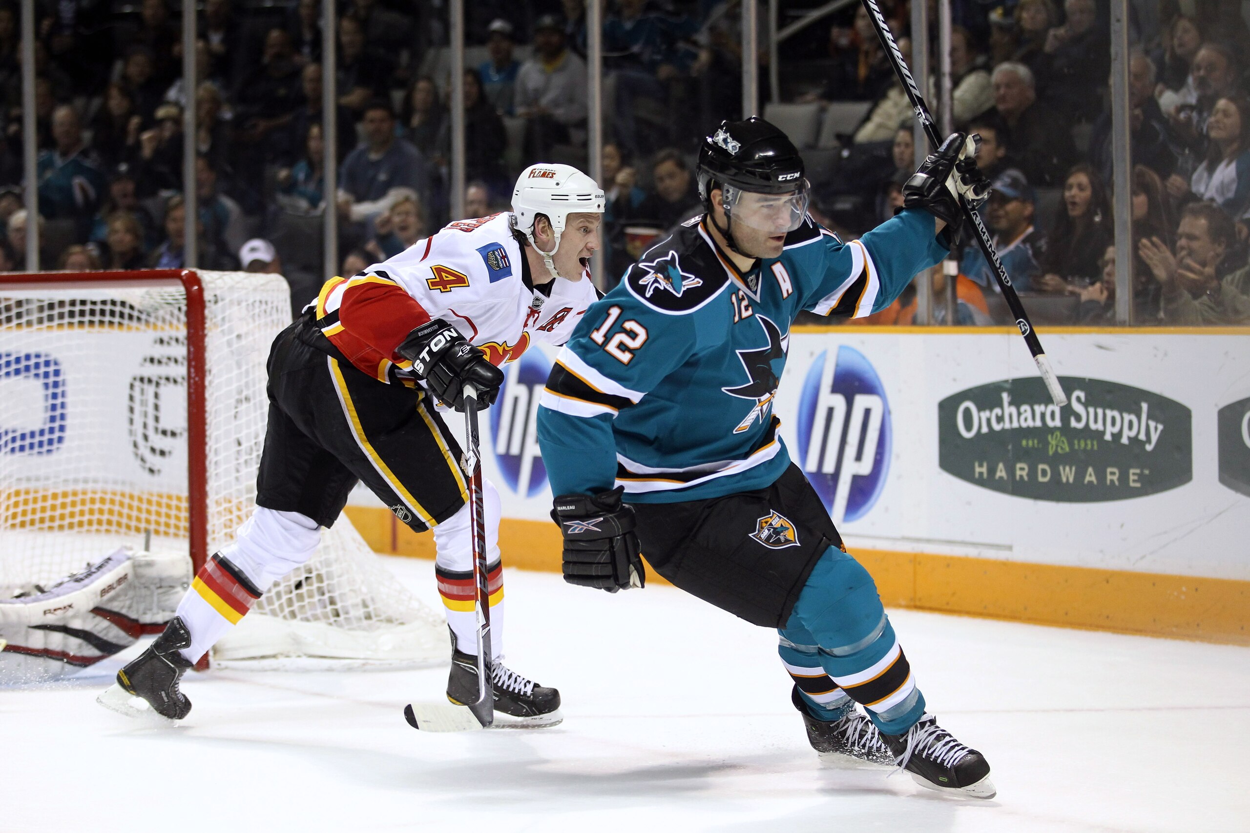 SAN JOSE, CA - MARCH 23:  Patrick Marleau #12 of the San Jose Sharks celebrates in front of Jay Bouwmeester #4 of the Calgary Flames after he scored a goal at the HP Pavilion on March 23, 2011 in San Jose, California.  (Photo by Ezra Shaw/Getty Images)