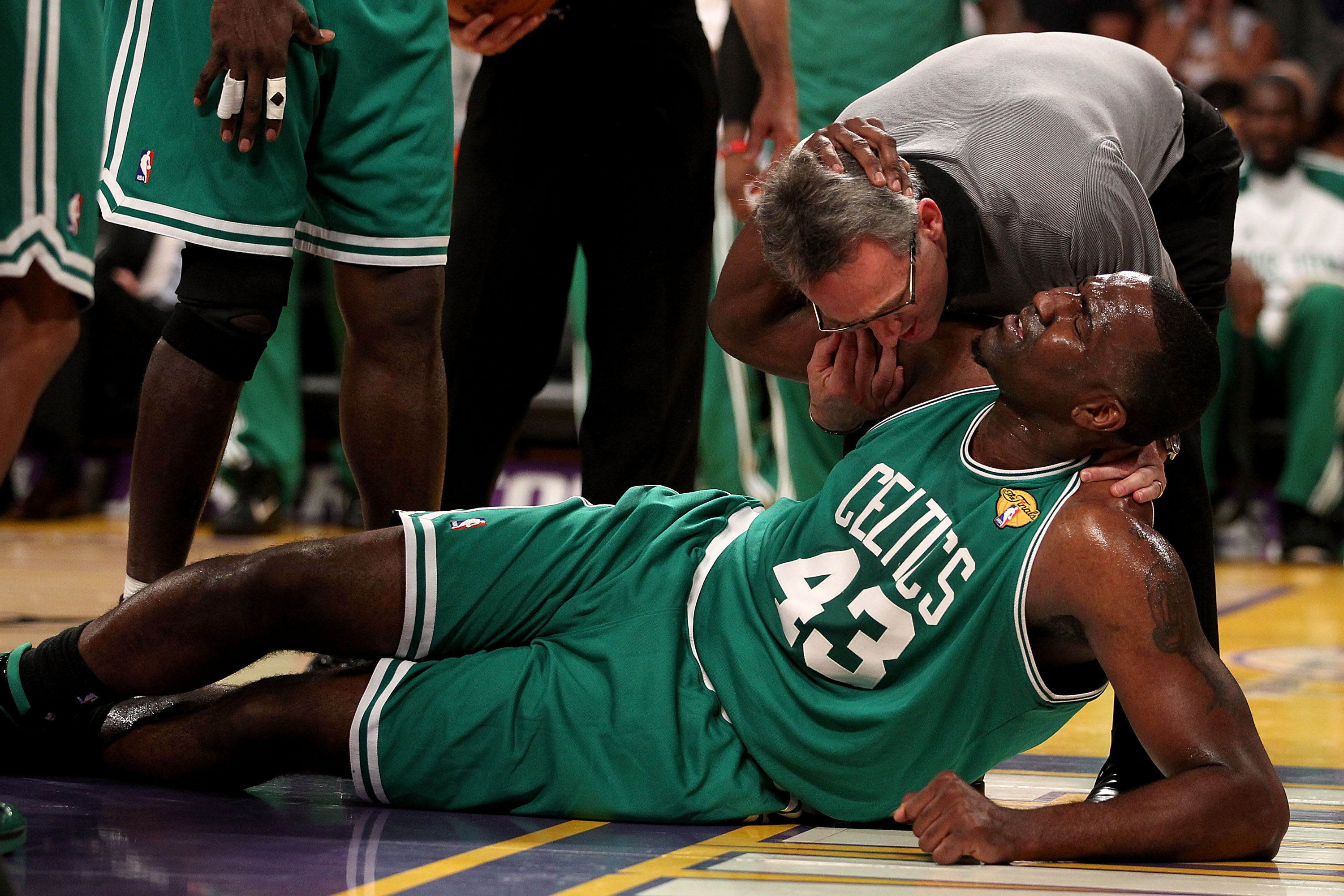 LOS ANGELES, CA - JUNE 15:  Kendrick Perkins #43 of the Boston Celtics is attended to by the trainer in the first half against the Los Angeles Lakers in Game Six of the 2010 NBA Finals at Staples Center on June 15, 2010 in Los Angeles, California.  NOTE T