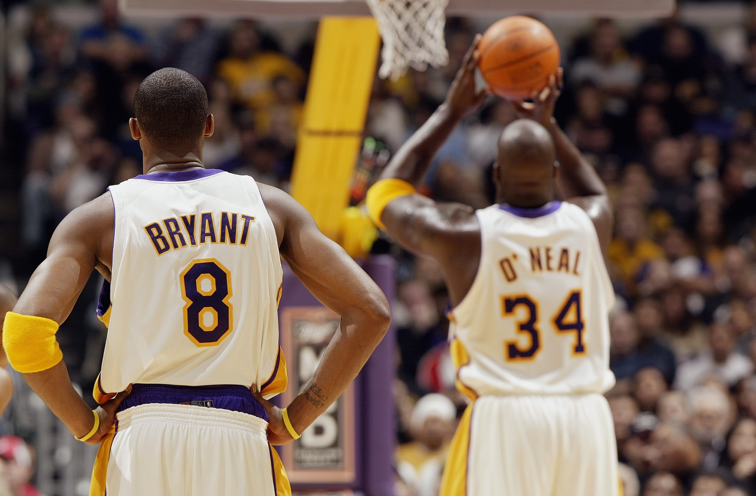 LOS ANGELES - NOVEMBER 30:  Kobe Bryant #8 of the Los Angeles Lakers watches teammate Shaquille O'Neal #34 shoot a free throw during the game against the Indiana Pacers at Staples Center on November 30, 2003 in Los Angeles, California.  The Lakers won 99-