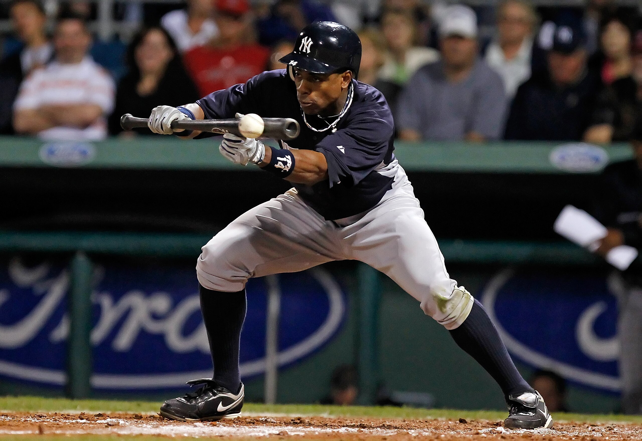 FORT MYERS, FL - MARCH 14:  Outfielder Curtis Granderson #14 of the New York Yankees bunts for a single against the Boston Red Sox during a Grapefruit League Spring Training Game at City of Palms Park on March 14, 2011 in Fort Myers, Florida.  (Photo by J