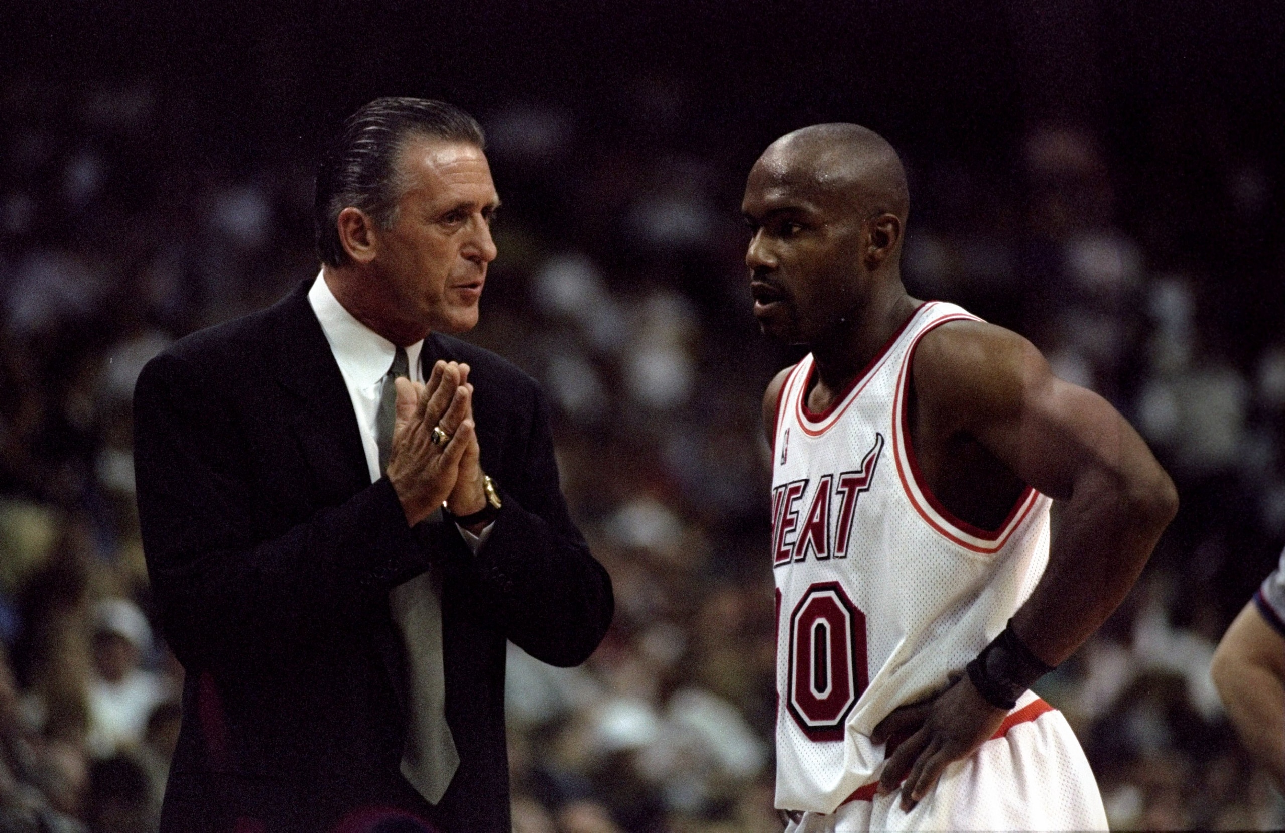 26 Apr 1998: Head coach Pat Riley of the Miami Heat talks to his guard Tim Hardaway during an NBA playoff game against the New York Knicks at the Miami Arena in Miami, Florida. The Knicks defeated the Heat 96-86.