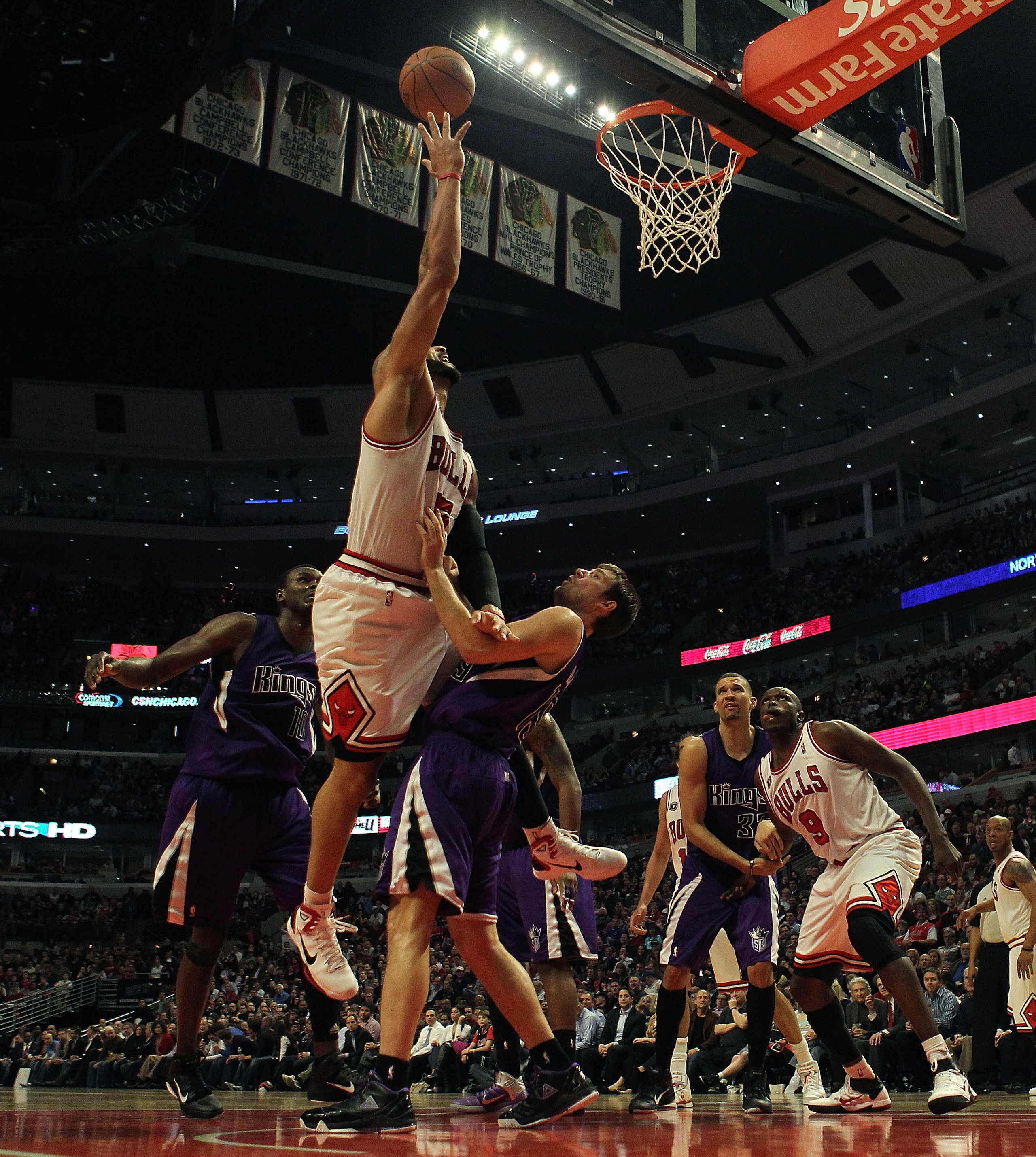 CHICAGO, IL - MARCH 21: Carlos Boozer #5 of the Chicago Bulls puts up a shot over Beno Udrih #19 of the Sacramento Kings at the United Center on March 21, 2011 in Chicago, Illinois. The Bulls defeated the Kings 132-92. NOTE TO USER: User expressly acknowl