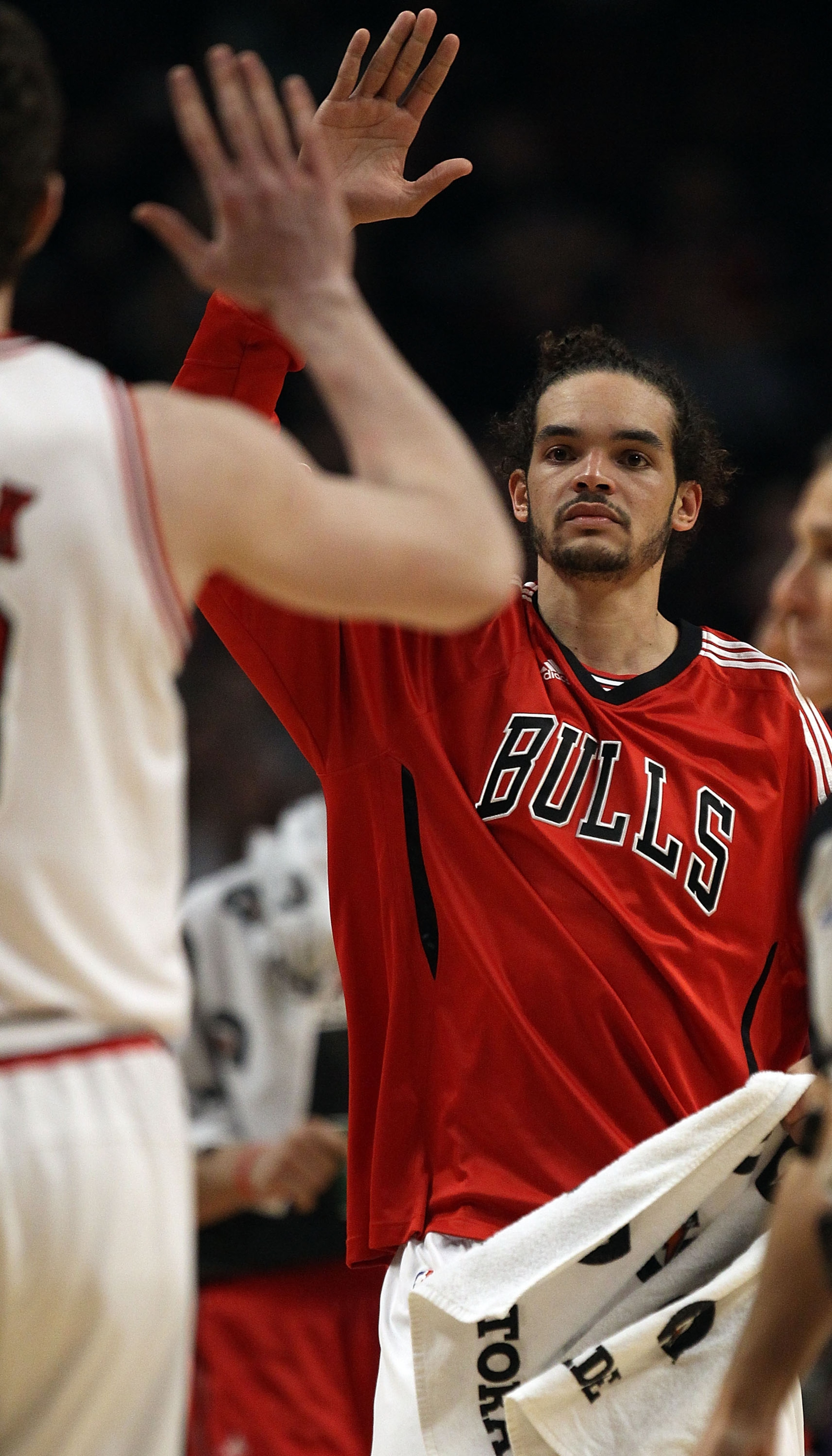 CHICAGO, IL - MARCH 21: Joakim Noah #13 of the Chicago Bulls greets a teammate during a time-out against the Sacramento Kings at the United Center on March 21, 2011 in Chicago, Illinois. The Bulls defeated the Kings 132-92. NOTE TO USER: User expressly ac