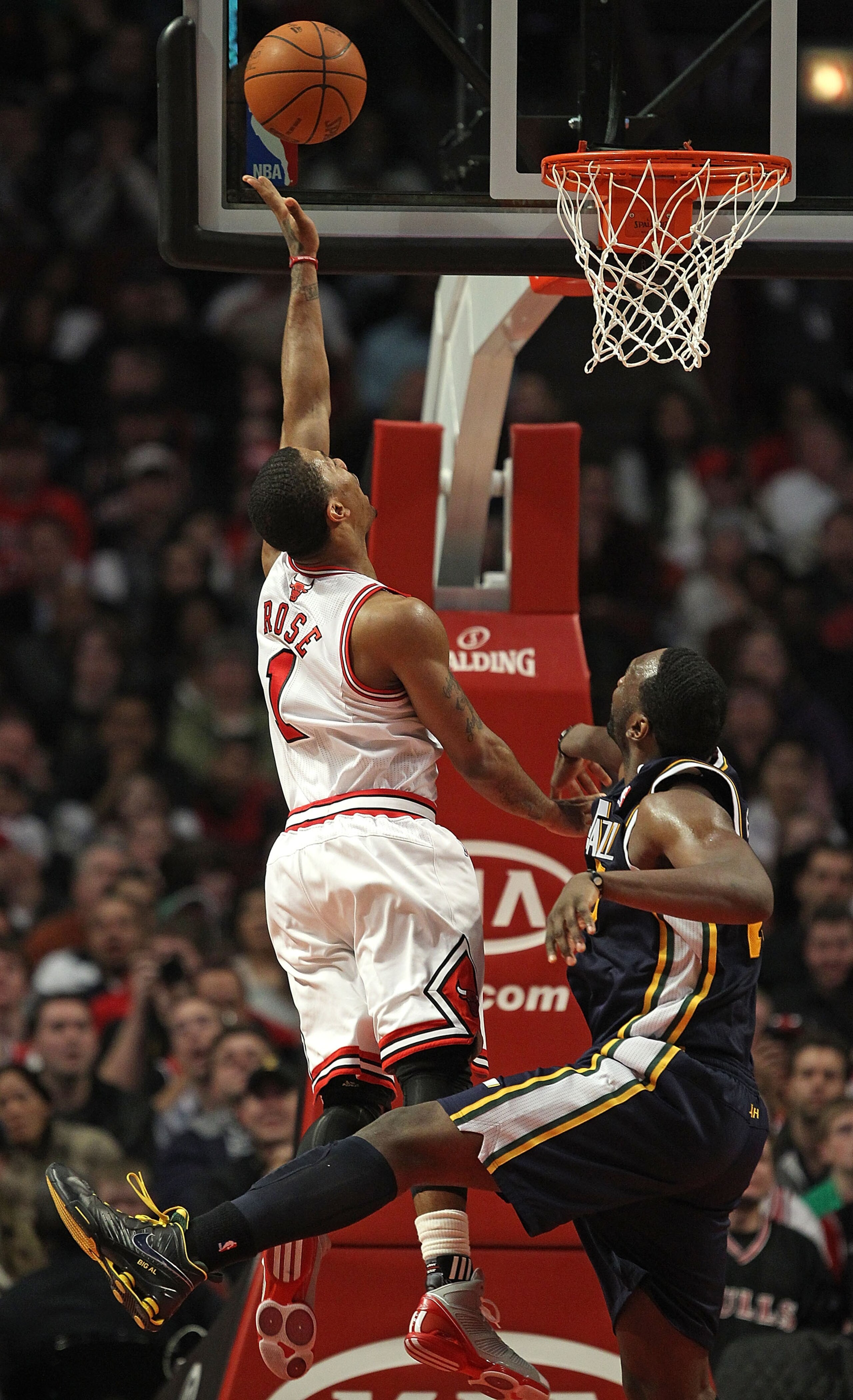 CHICAGO, IL - MARCH 12: Derrick Rose #1 of the Chicago Bulls puts up a shot over Al Jefferson #25 of the Utah Jazz at the United Center on March 12, 2011 in Chicago, Illinois. The Bulls defeated the Jazz 118-100. NOTE TO USER: User expressly acknowledges