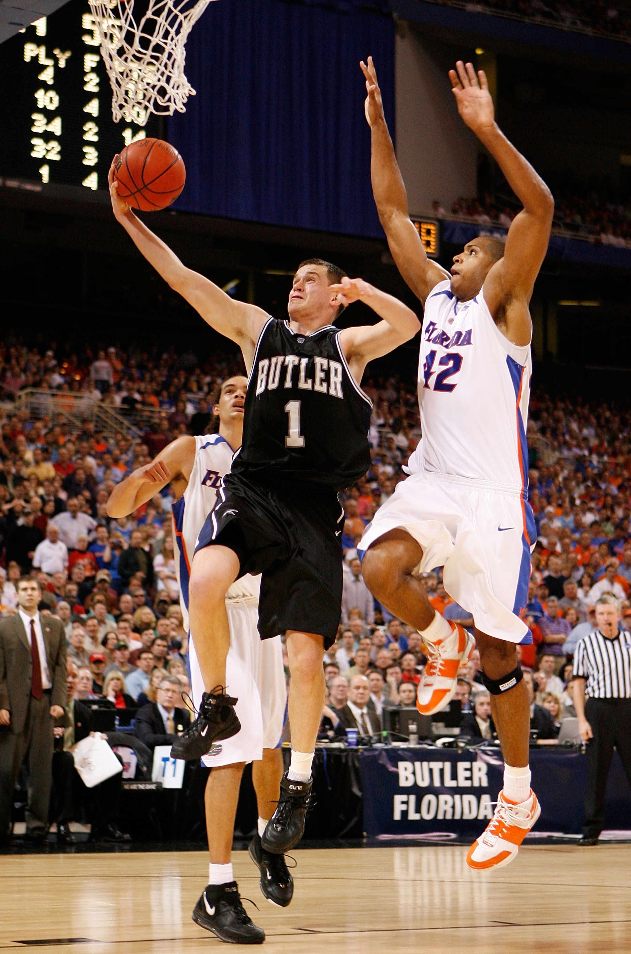ST. LOUIS - MARCH 23:  Julian Betko #1 of the Butler Bulldogs drives to the basket in front of Al Horford #42 of the Florida Gators during the midwest regionals of the NCAA Men's Basketball Tournament at the Edward Jones Dome on March 23, 2007 in St. Loui