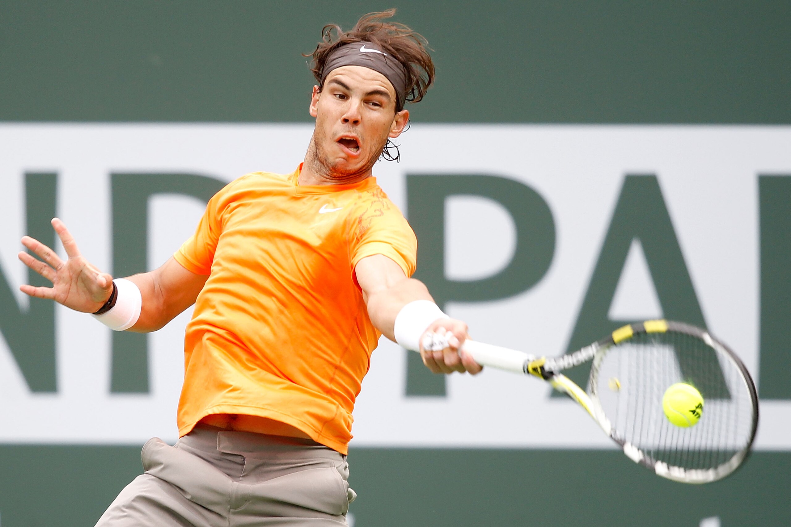 INDIAN WELLS, CA - MARCH 20: Rafael Nadal of Spain returns a shot to Novak Djokovic of Serbia during the final of the BNP Paribas Open at the Indian Wells Tennis Garden on March 20, 2011 in Indian Wells, California.  (Photo by Matthew Stockman/Getty Image