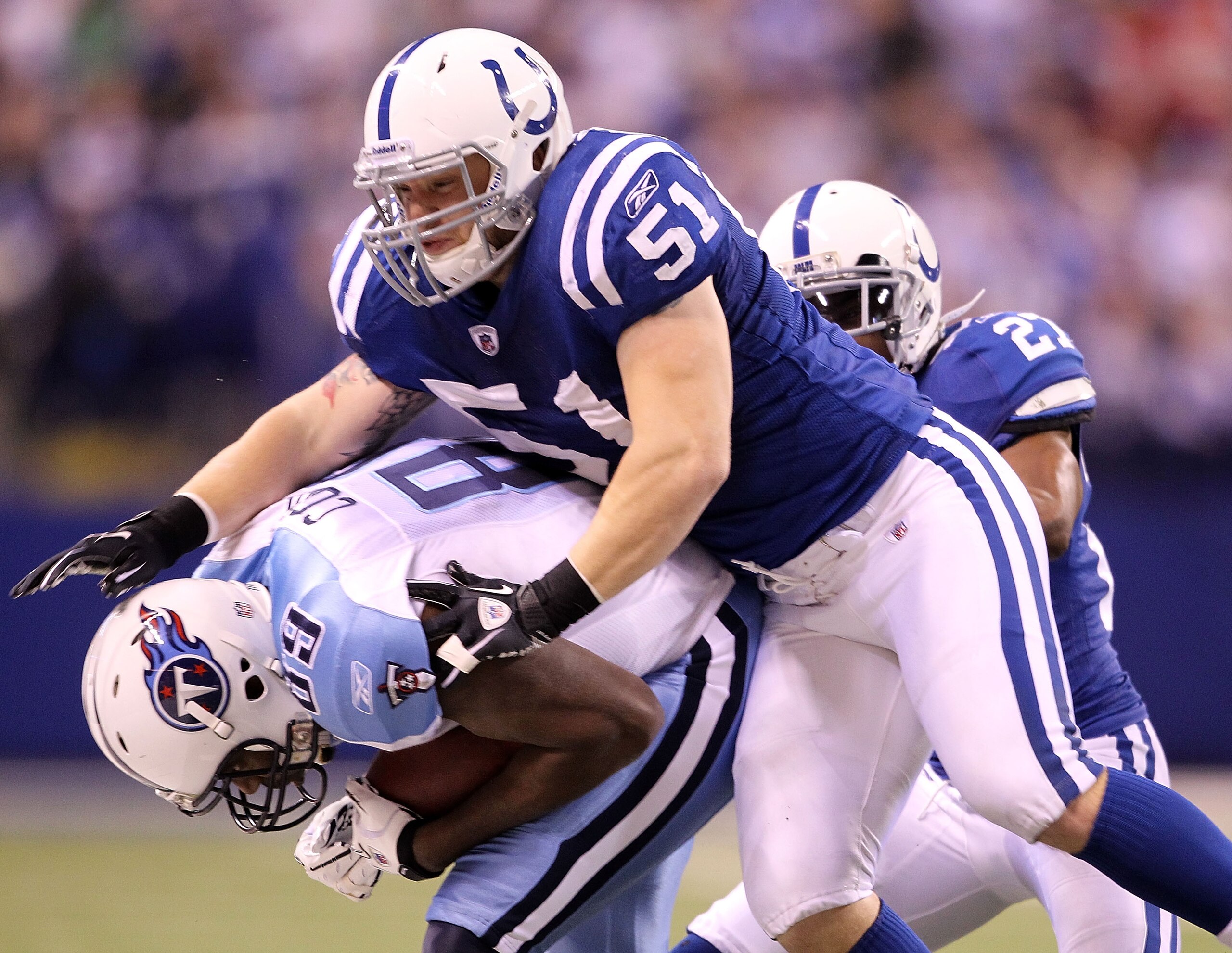 INDIANAPOLIS - JANUARY 02: Jared Cook #89 of the Tennessee Titans is tackled by Pat Angerer #51 of the Indianapolis Colts at Lucas Oil Stadium on January 2, 2011 in Indianapolis, Indiana.  The Colts won 23-20.  (Photo by Andy Lyons/Getty Images)