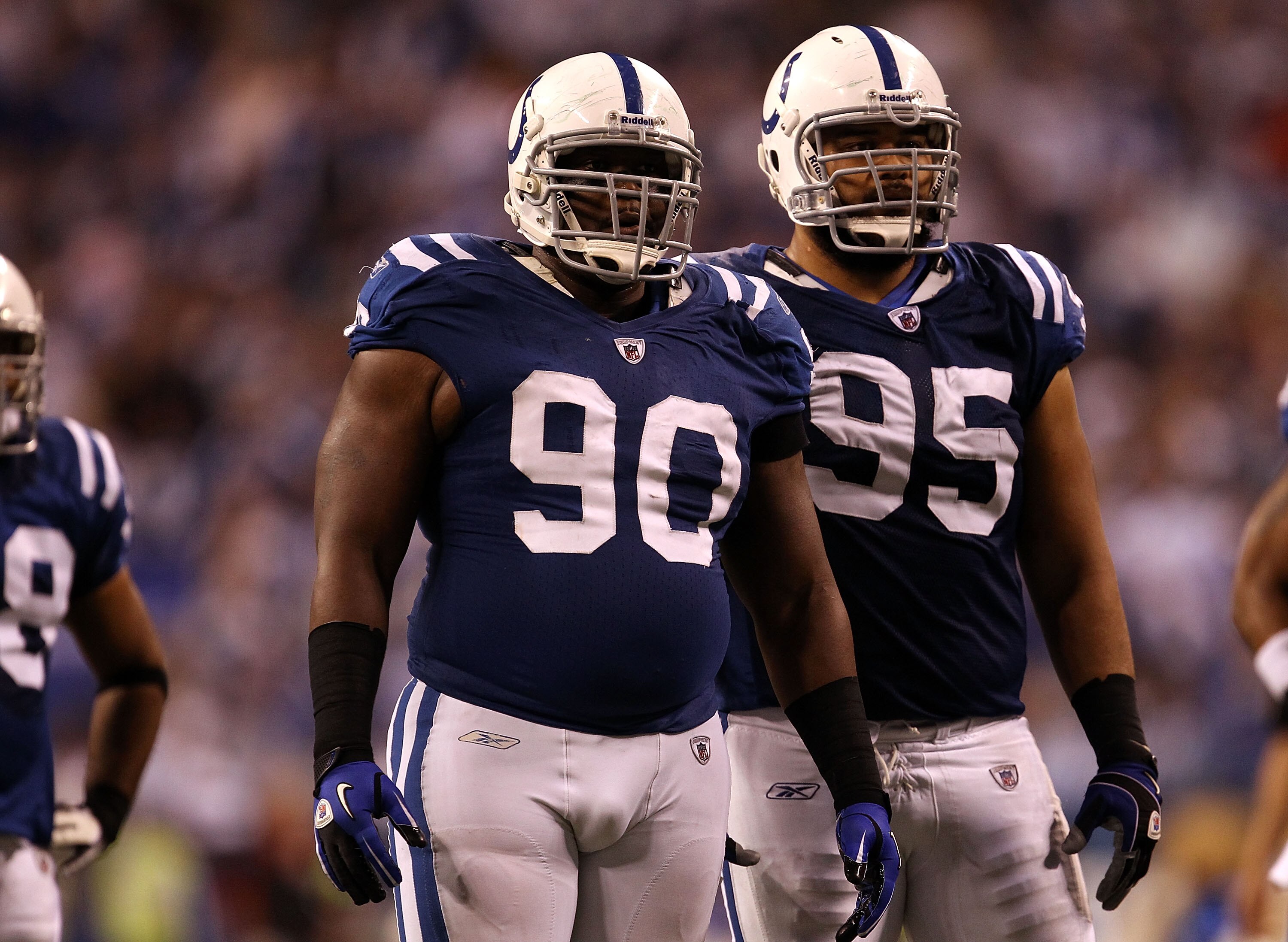 INDIANAPOLIS, IN - JANUARY 08:  (L-R) Dan Muir #90 and Fili Moala #95 of the Indianapolis Colts look on against the New York Jets during their 2011 AFC wild card playoff game at Lucas Oil Stadium on January 8, 2011 in Indianapolis, Indiana. The Jets won 1